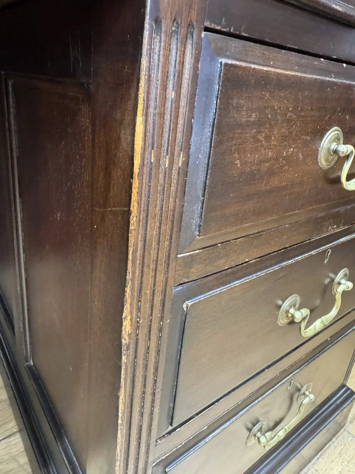 Twin antique mahogany writing desk with red leather top and brass swan-neck handles.