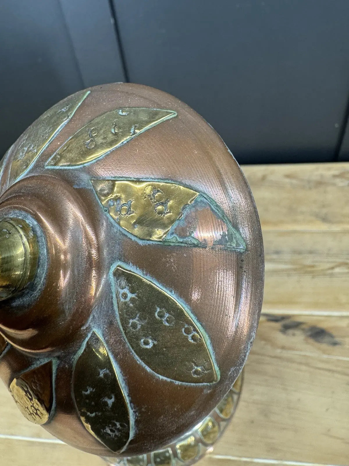 Antique Moroccan copper tea kettle and brass cauldron planter with ornate geometric patterns.