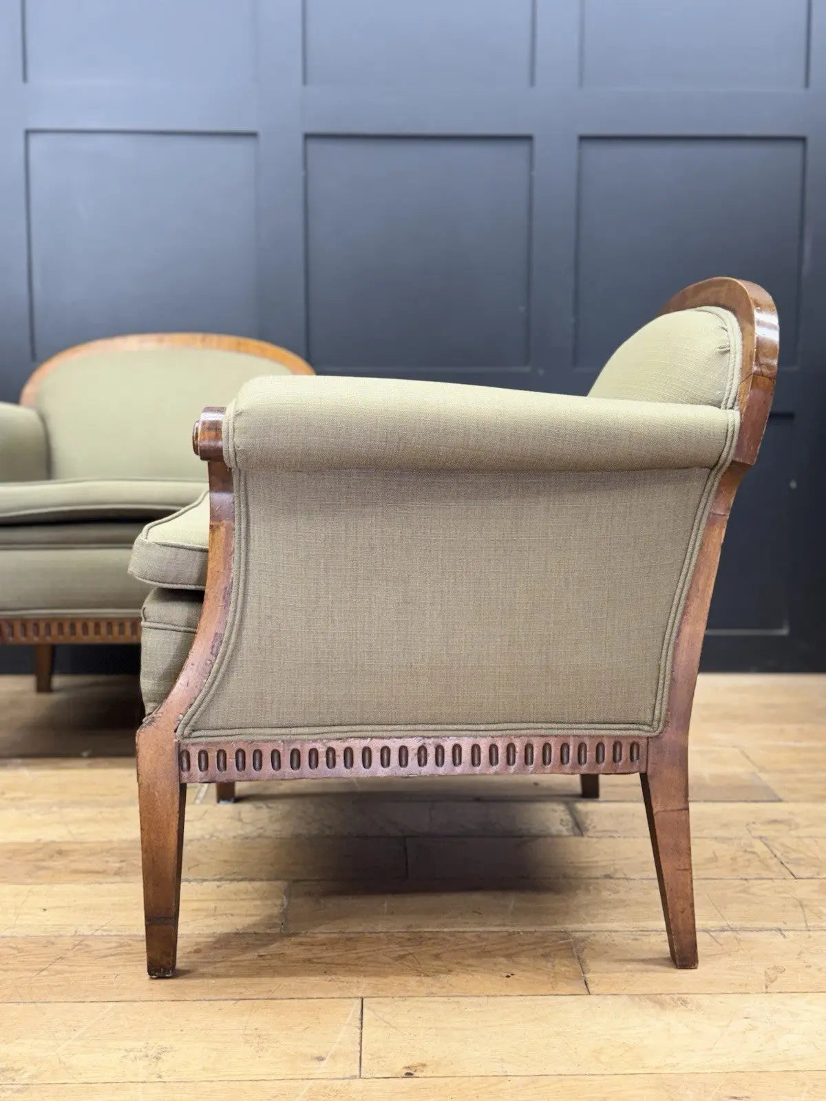 French's green Art Deco armchairs with walnut scroll arms and tapered legs.