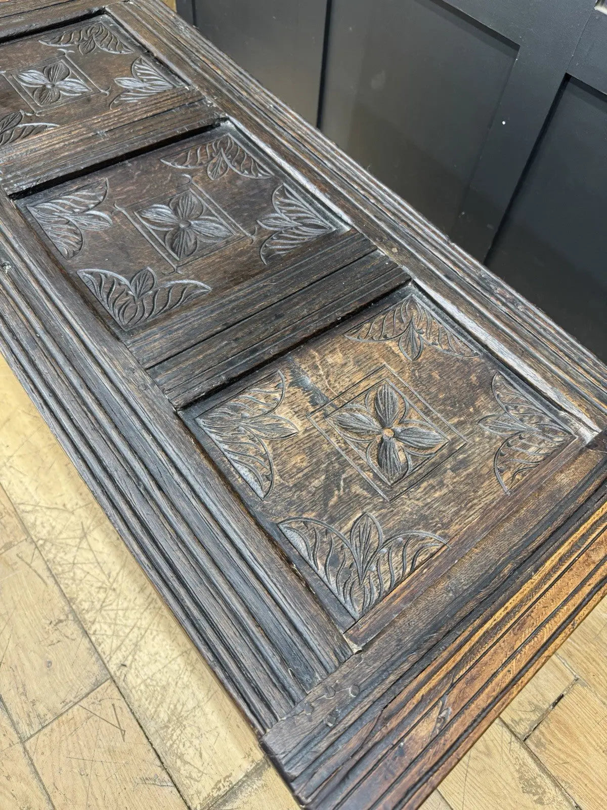 Georgian carved oak hope chest brown with floral motifs and iron hinges.