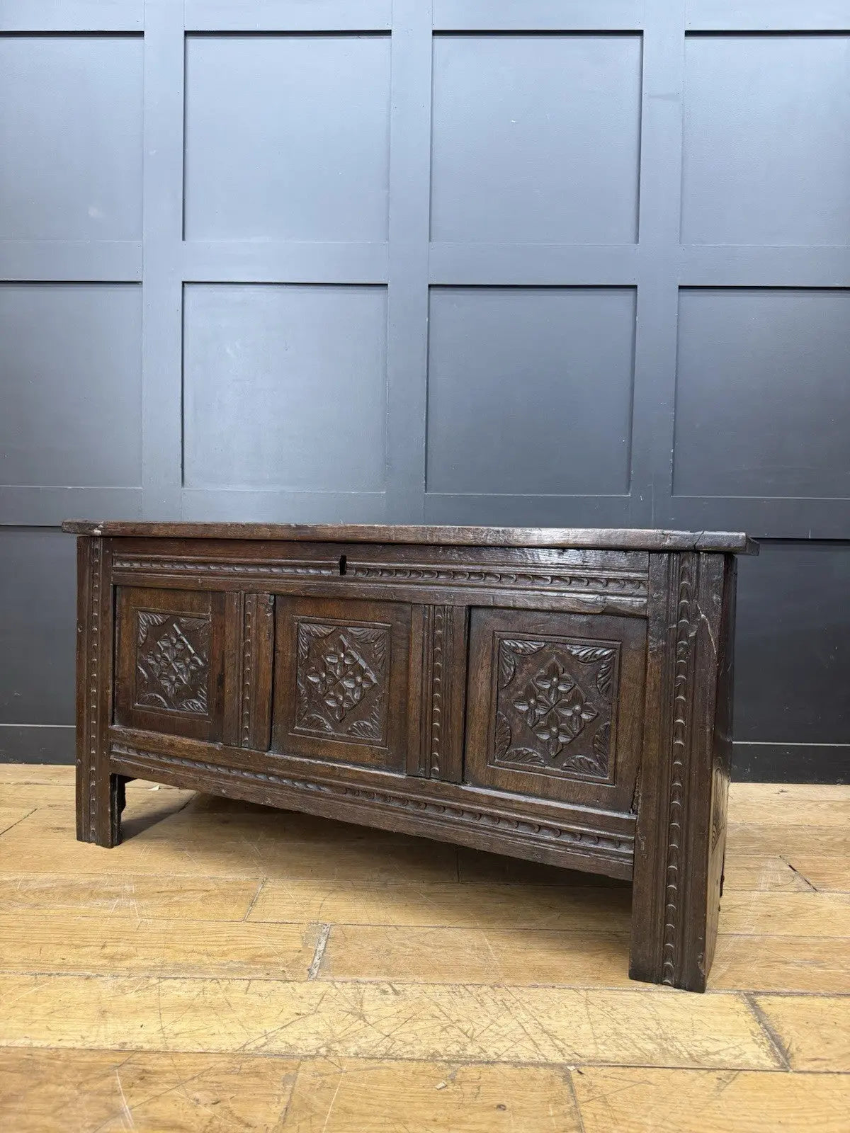 Georgian carved oak hope chest brown with floral motifs and iron hinges.