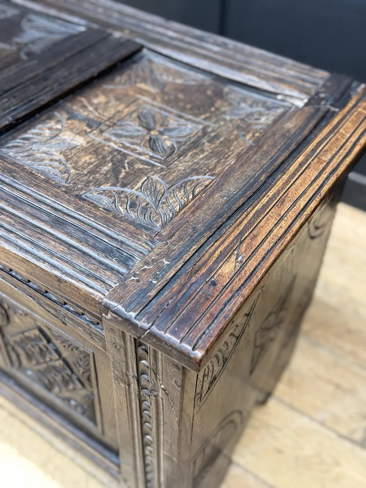 Georgian carved oak hope chest brown with floral motifs and iron hinges.