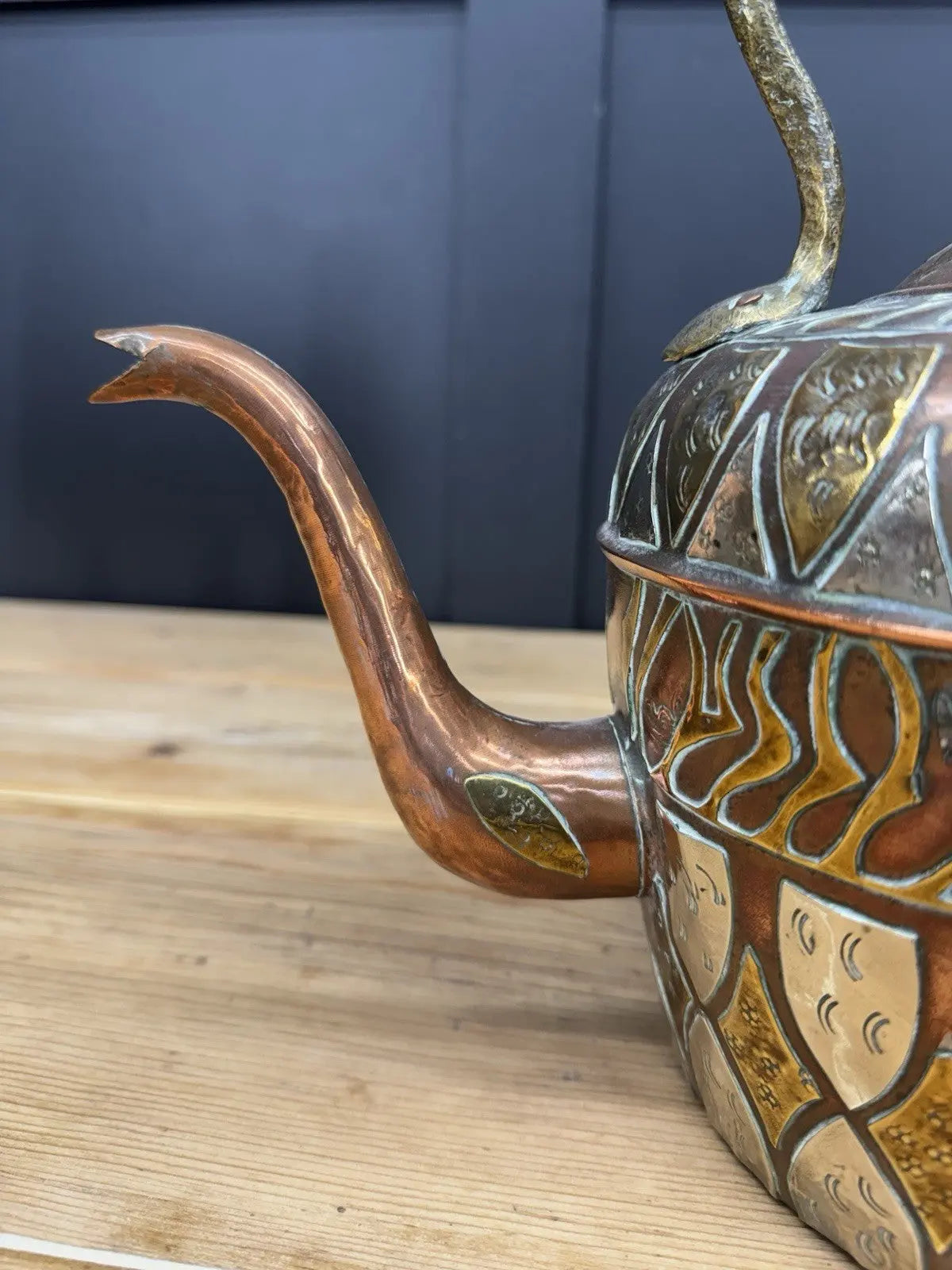 Antique Moroccan copper tea kettle and brass cauldron planter with ornate geometric patterns.