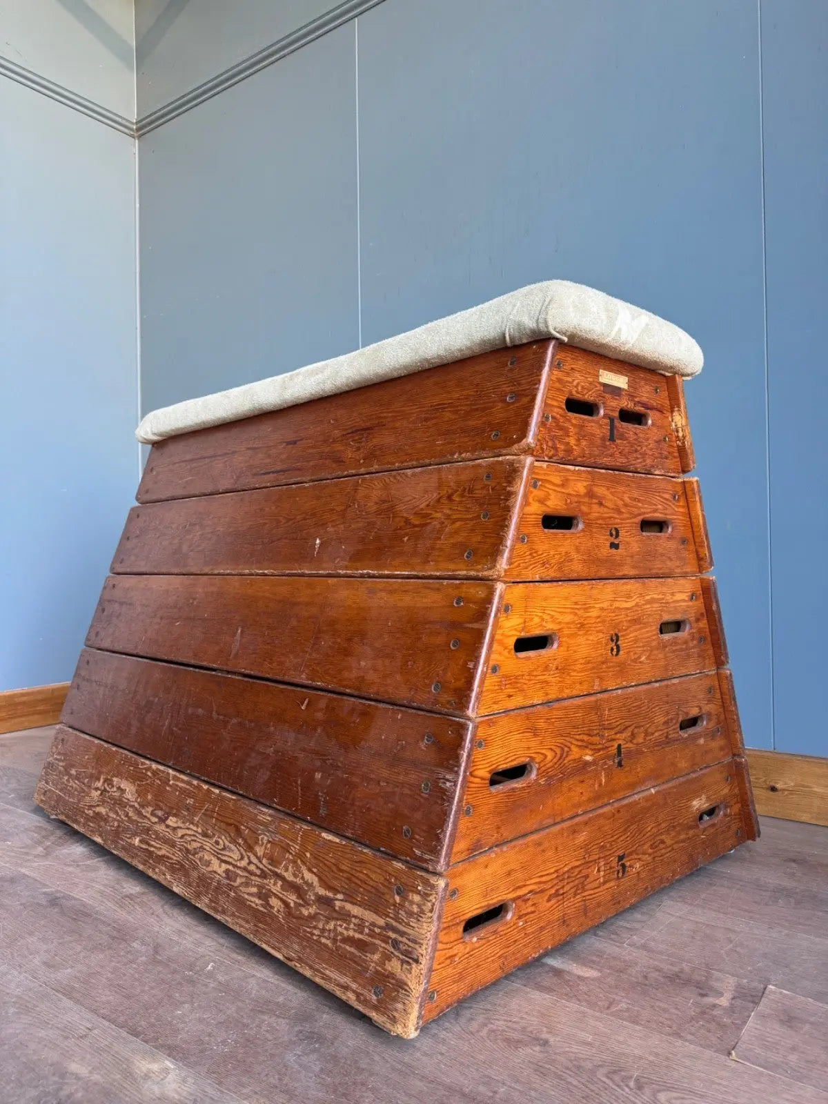 Lodge vintage wooden pommel horse with original maker's label, padded top, and worn patina.