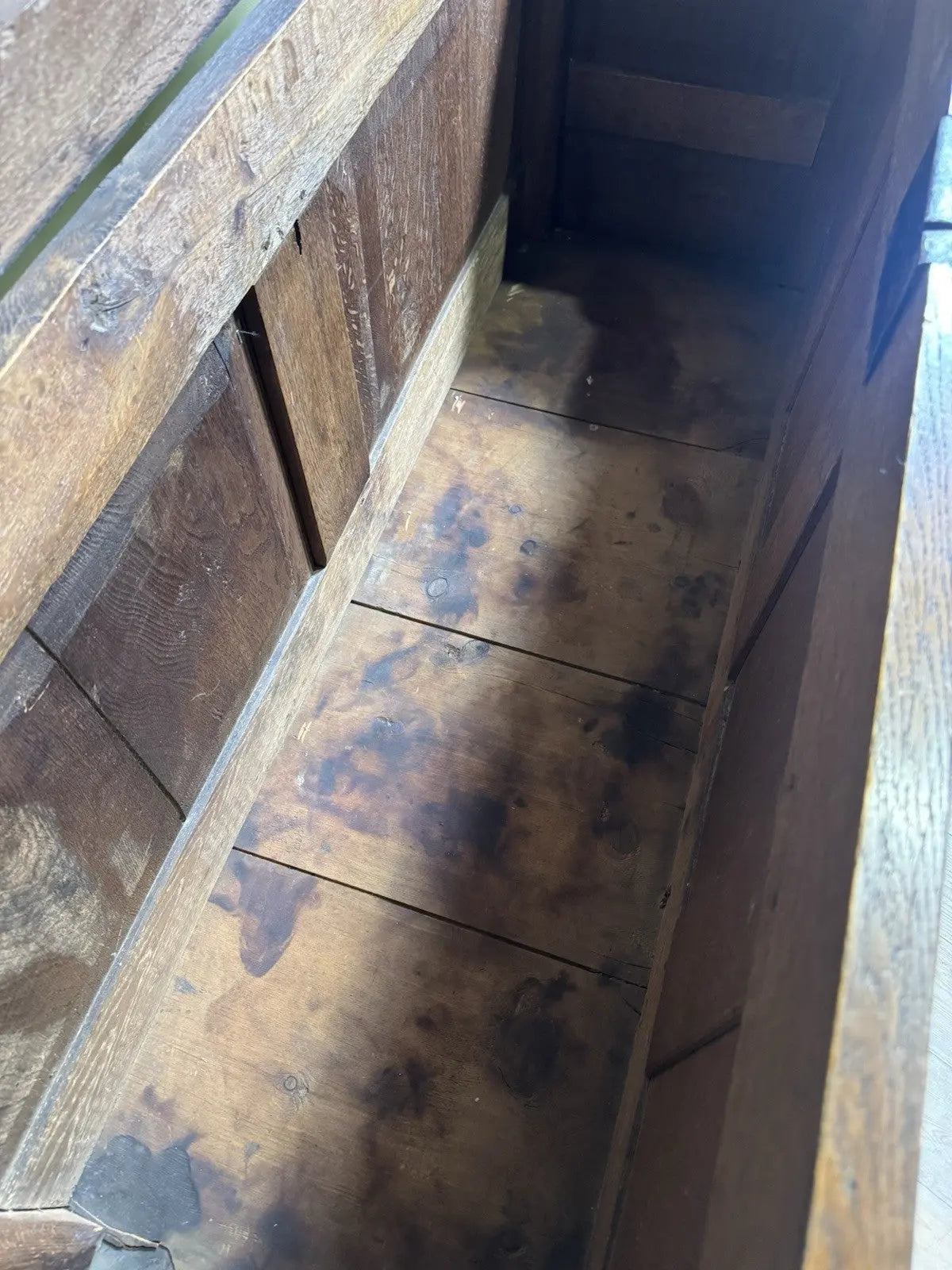 Antique oak mule chest brown four-panelled design with two drawers and rich grain.