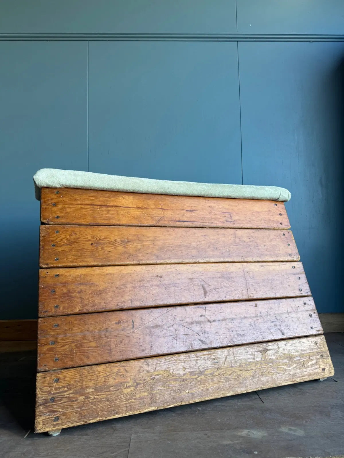 Lodge vintage wooden pommel horse with original maker's label, padded top, and worn patina.