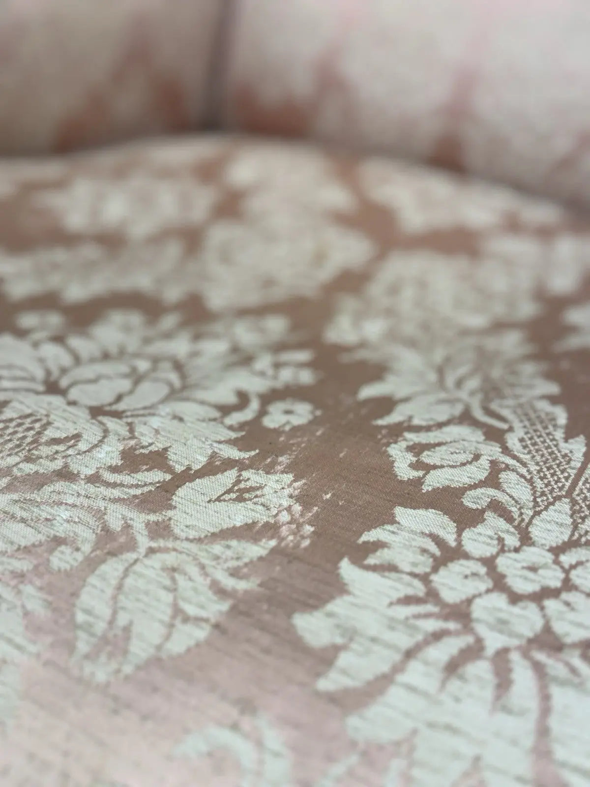 Late Victorian armchair pink silk damask floral pattern with curved rolled arms.