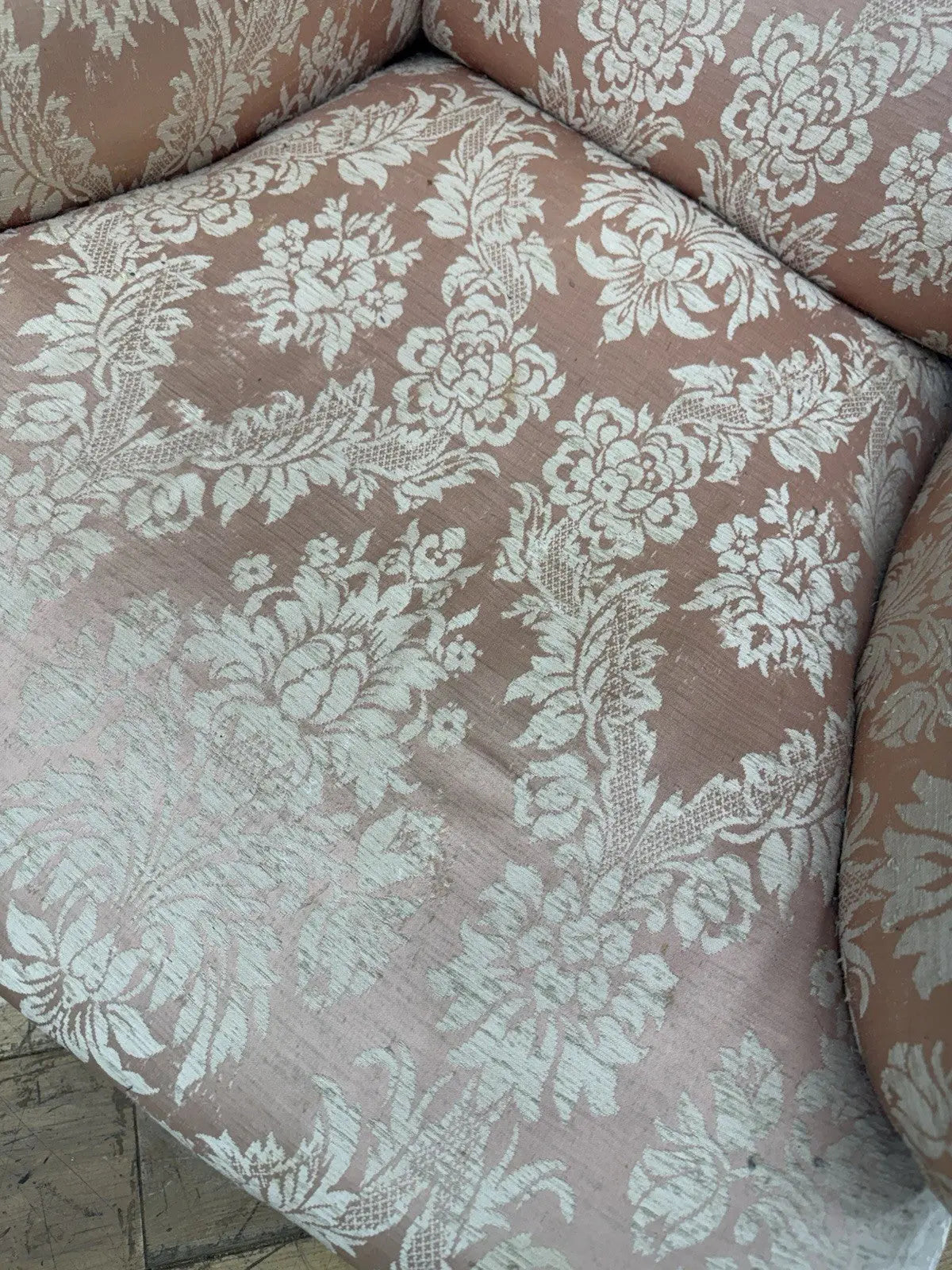 Late Victorian armchair pink silk damask floral pattern with curved rolled arms.