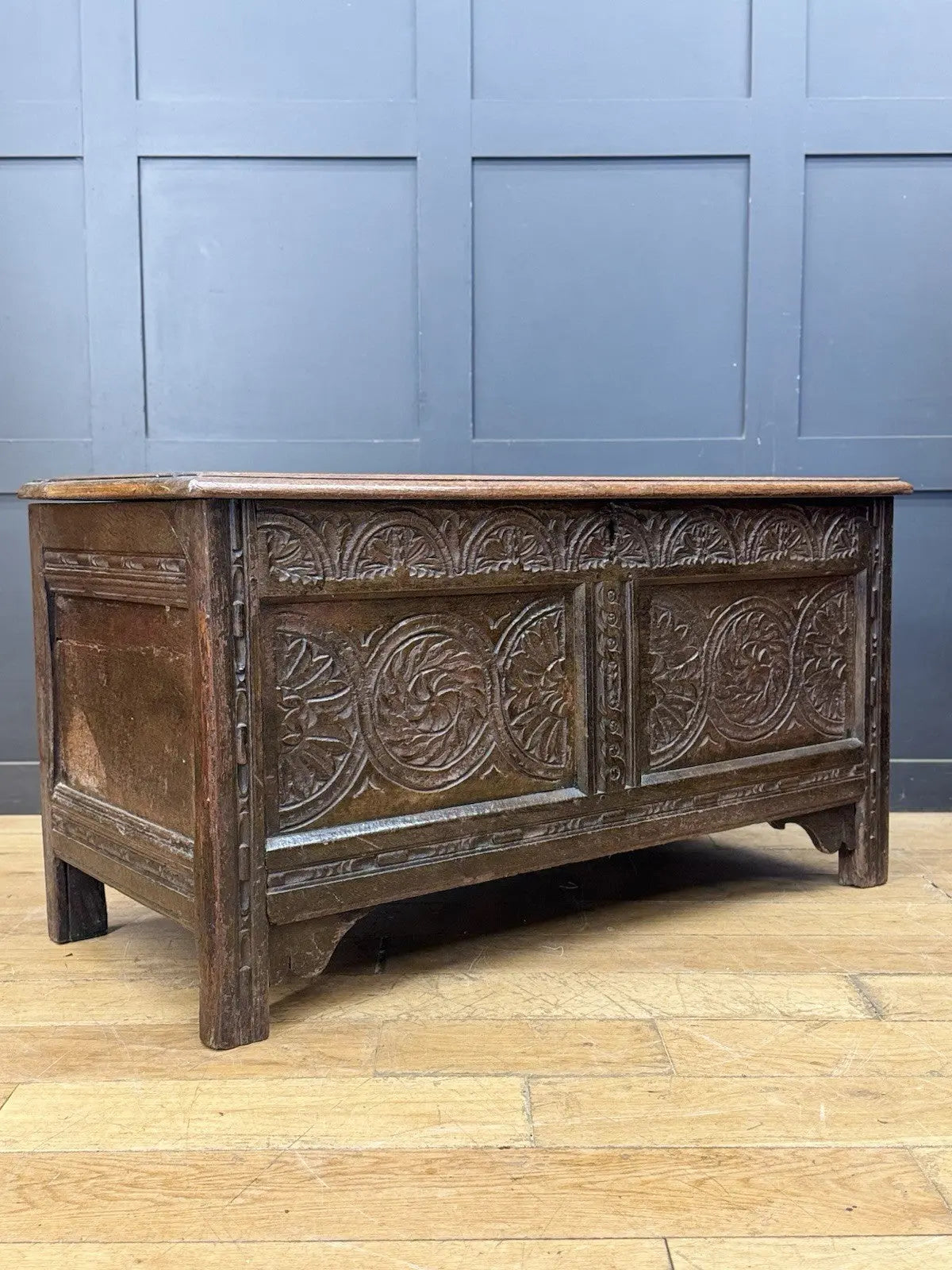 Antique oak hope chest brown with intricate floral carvings and spacious interior.