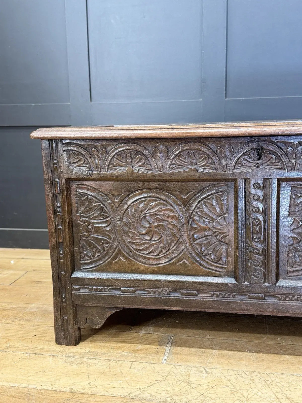 Antique oak hope chest brown with intricate floral carvings and spacious interior.