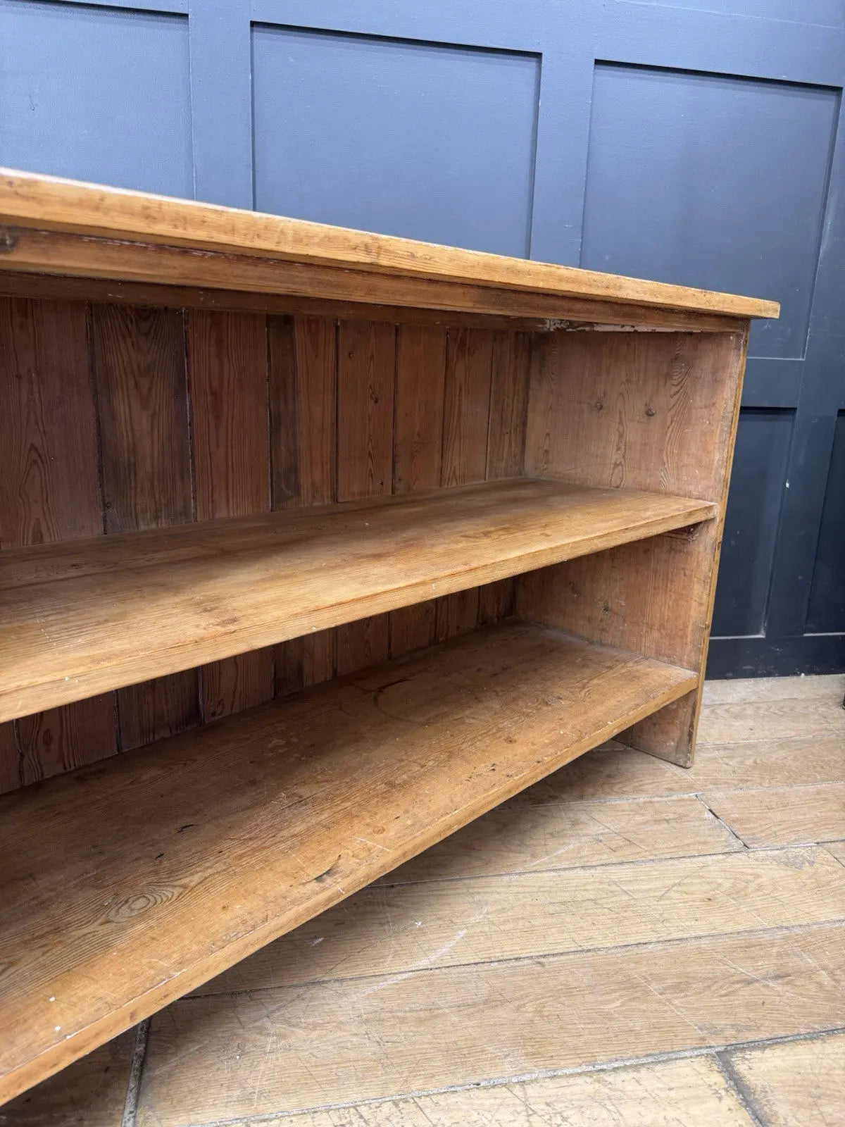 Vintage pine bookcase with warm, aged finish and two open shelves.