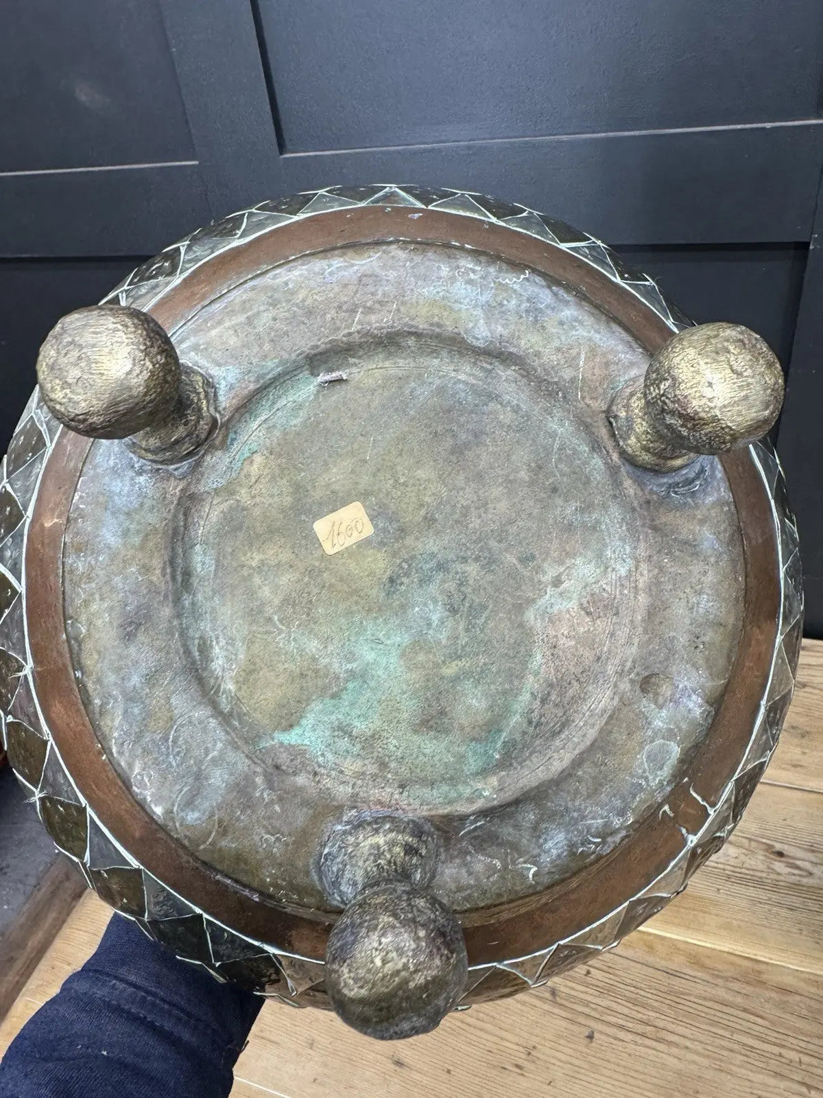 Antique Moroccan copper tea kettle and brass cauldron planter with ornate geometric patterns.