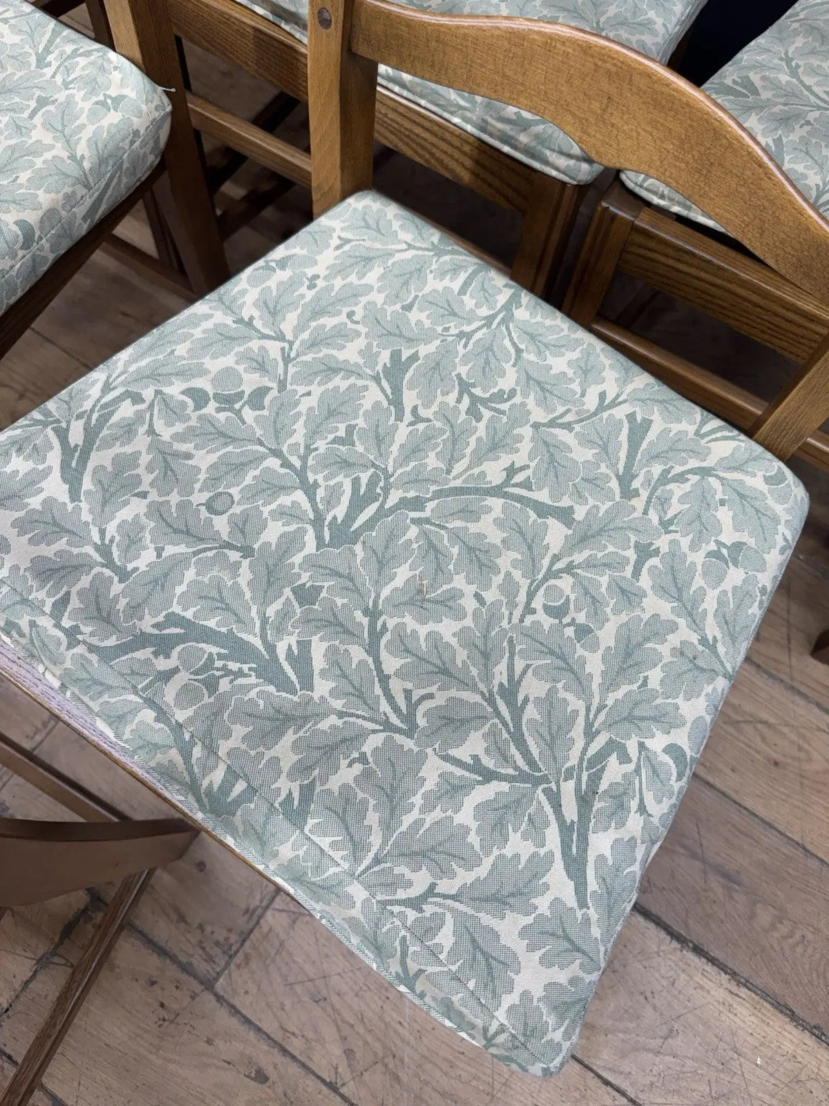 Ercol vintage ladderback dining chairs brown elm beech with green botanical patterned seat pads.