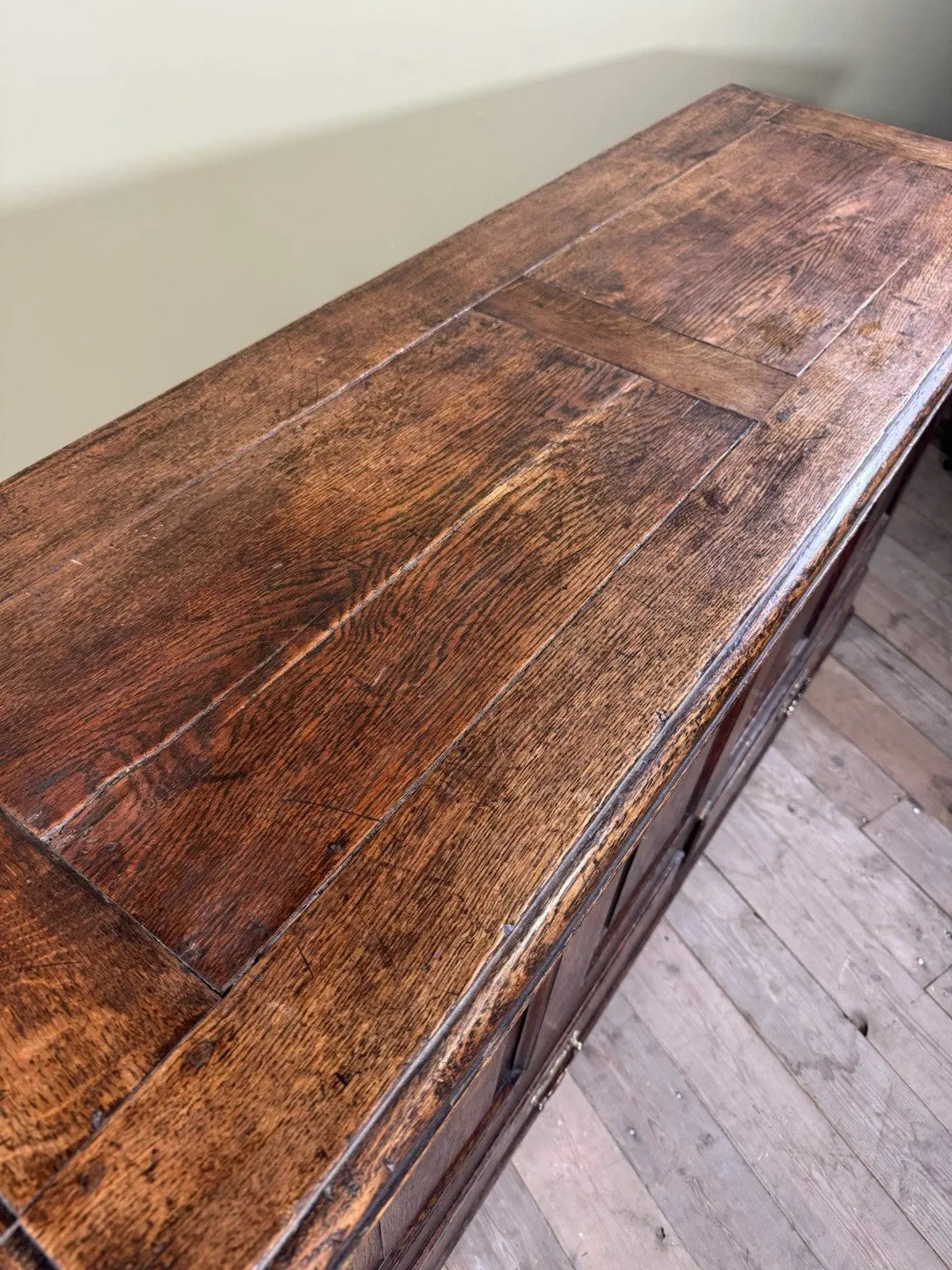 Antique oak mule chest brown four-panelled design with two drawers and rich grain.