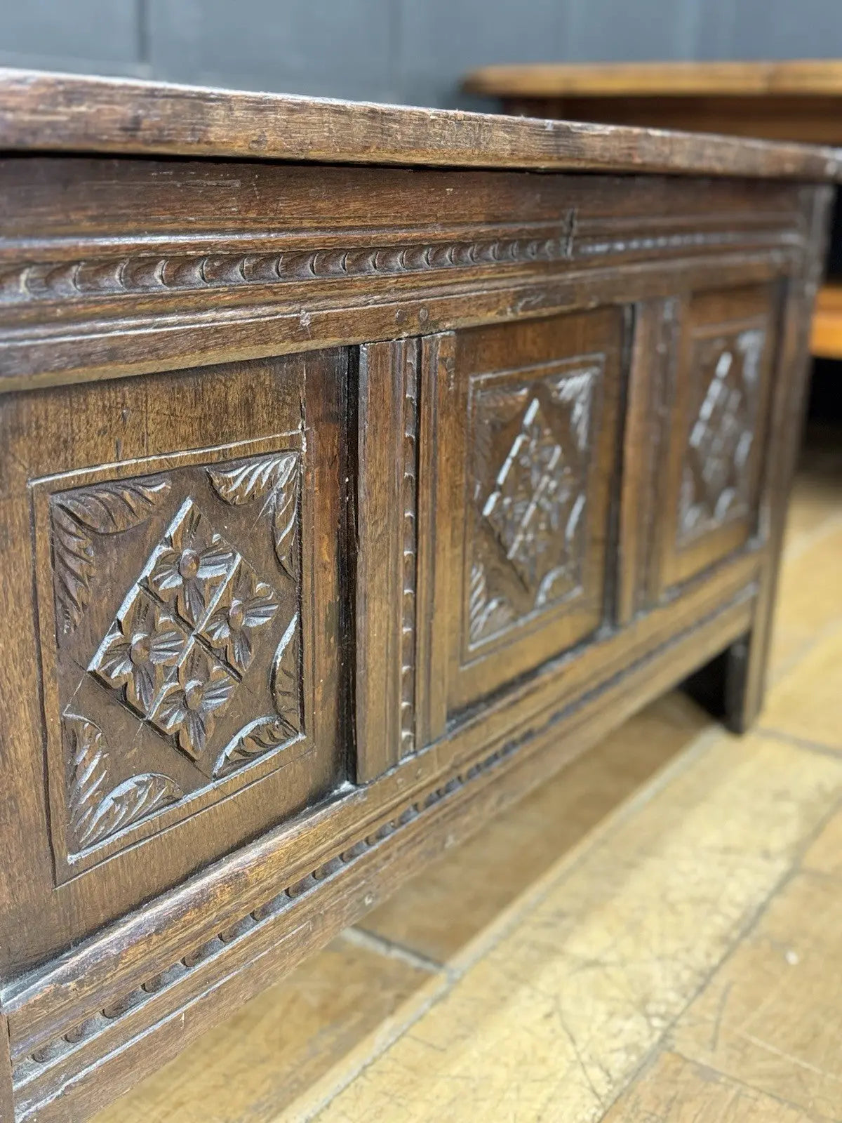 Georgian carved oak hope chest brown with floral motifs and iron hinges.