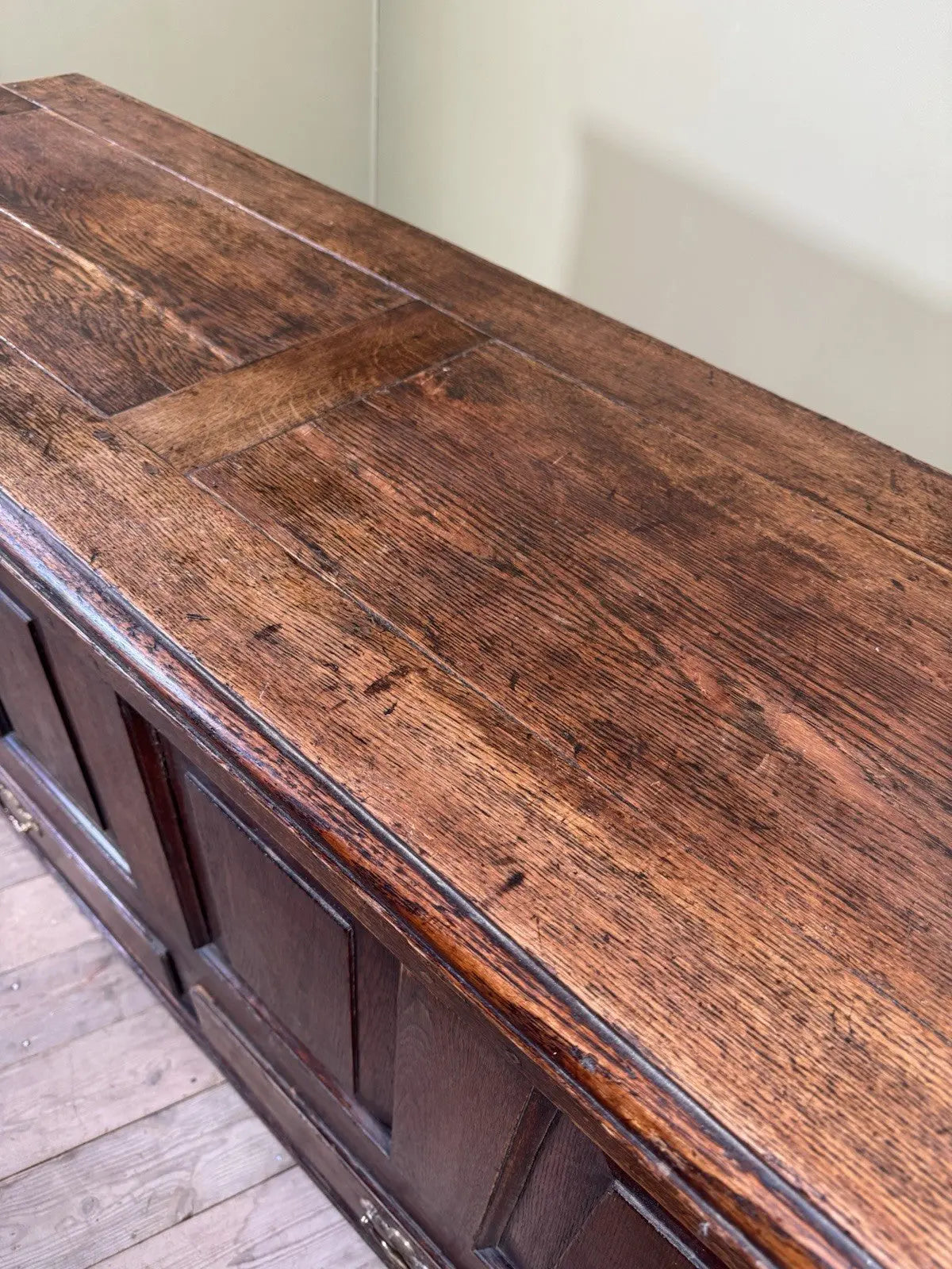Antique oak mule chest brown four-panelled design with two drawers and rich grain.