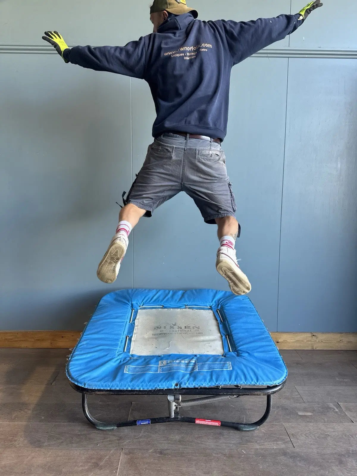 Rebounder black and blue gymnastics trampette with Nissen International logo and woven jumping bed.