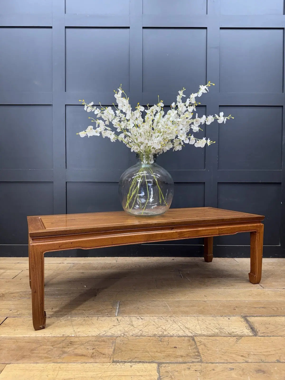 Contemporary Chinese hardwood coffee table brown rectangular top with framed construction and square legs.