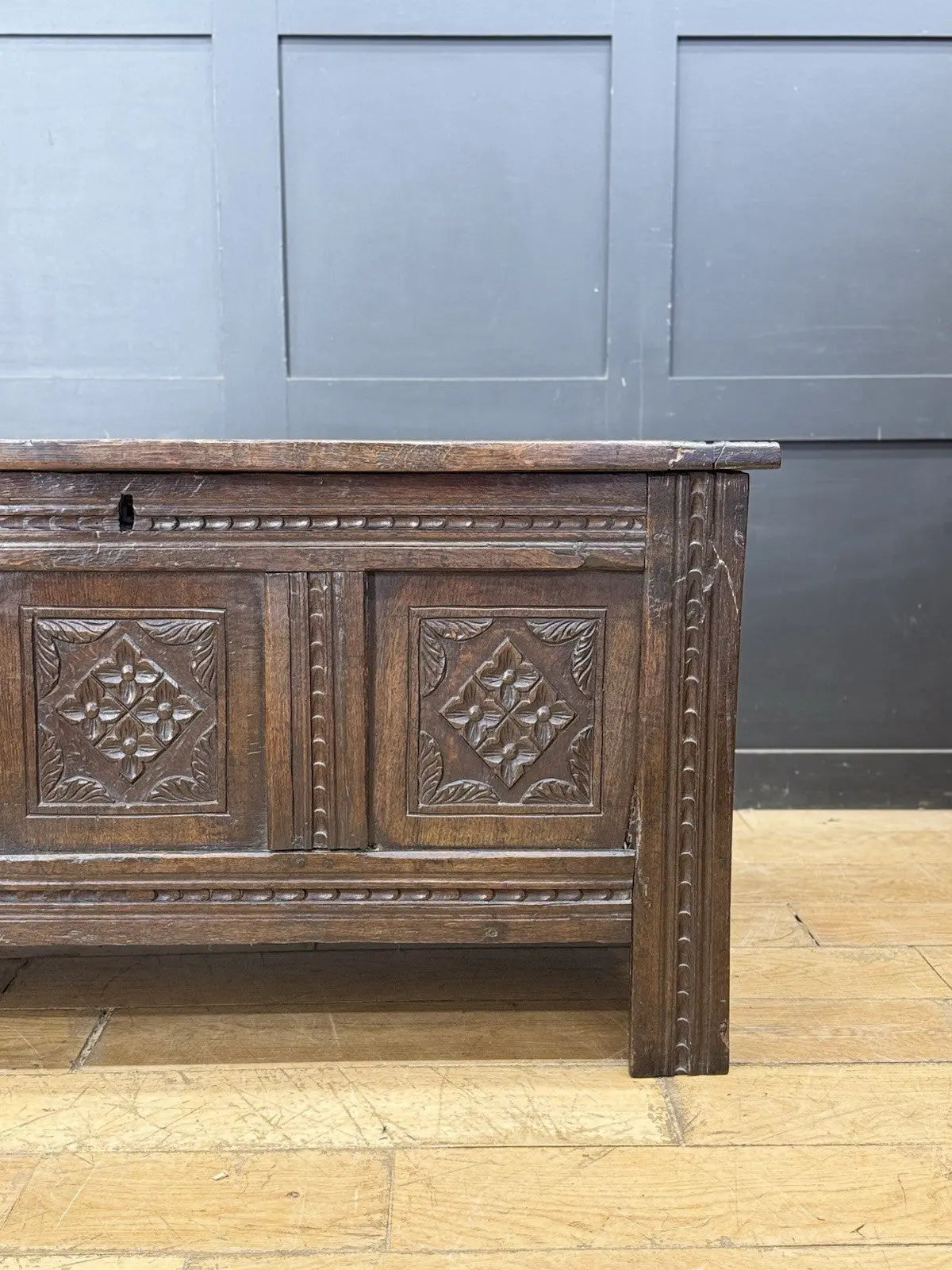 Georgian carved oak hope chest brown with floral motifs and iron hinges.