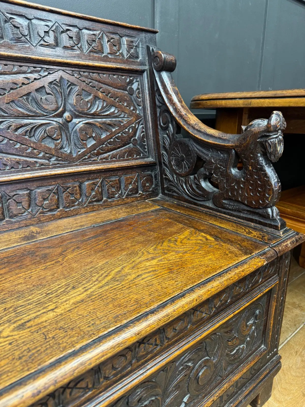 Victorian carved oak hall bench, brown, intricate Gothic Revival carvings and mythical figures.