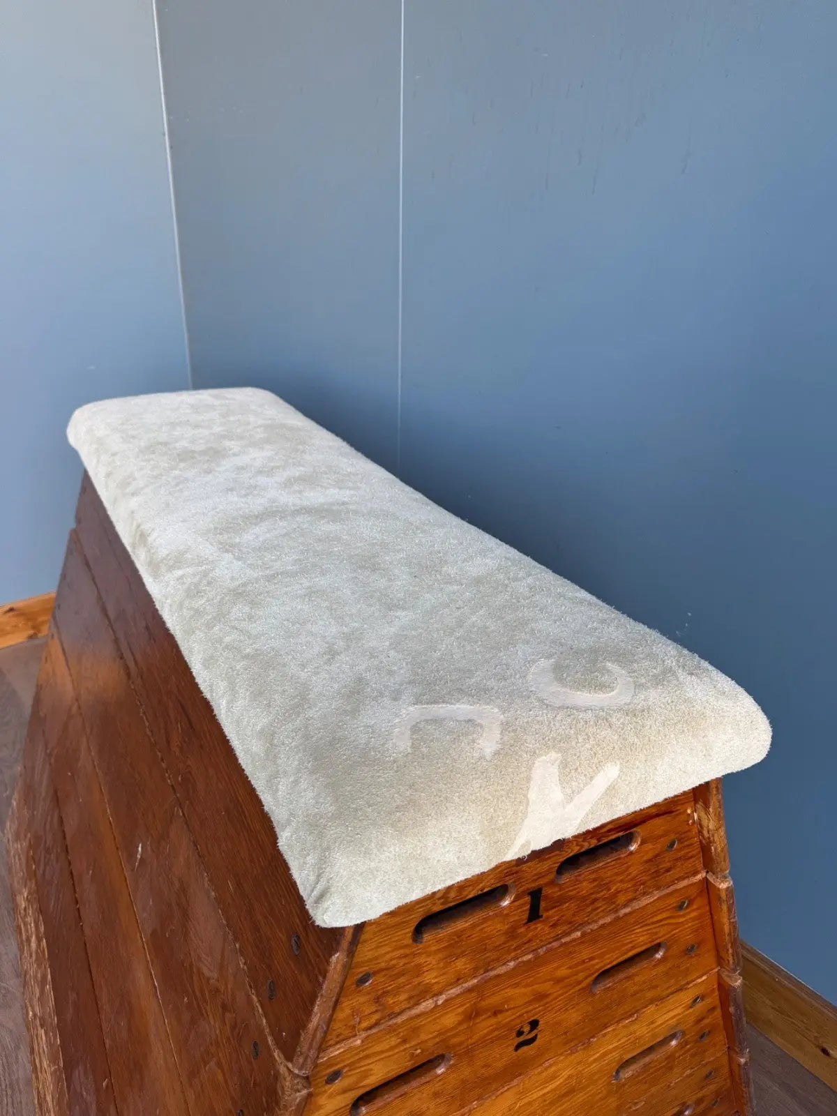 Lodge vintage wooden pommel horse with original maker's label, padded top, and worn patina.