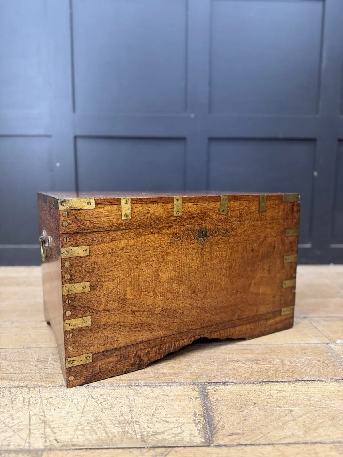 Antique Anglo-Burmese teak campaign chest trunk with brass strapwork and drop-handle.