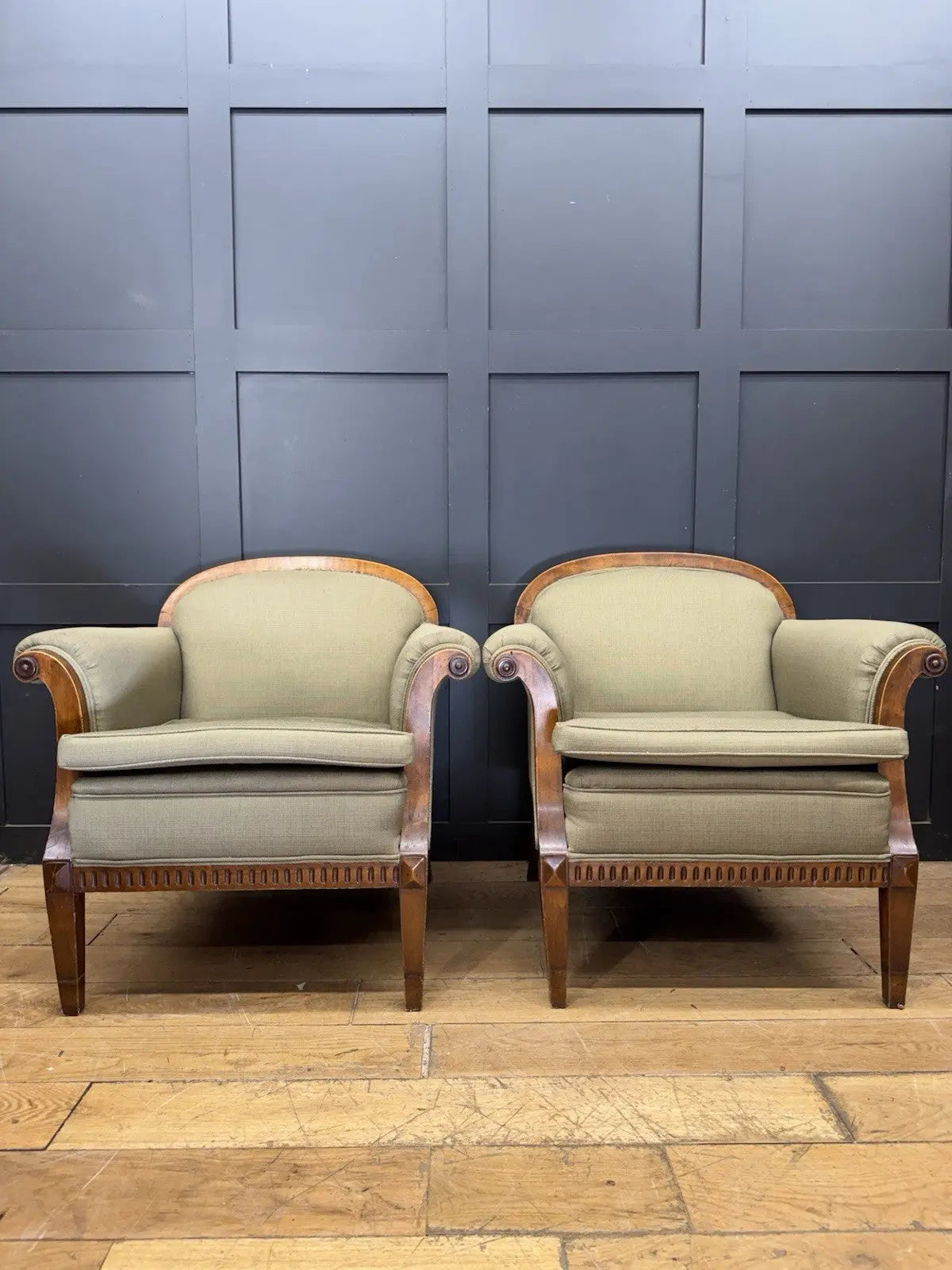 French's green Art Deco armchairs with walnut scroll arms and tapered legs.