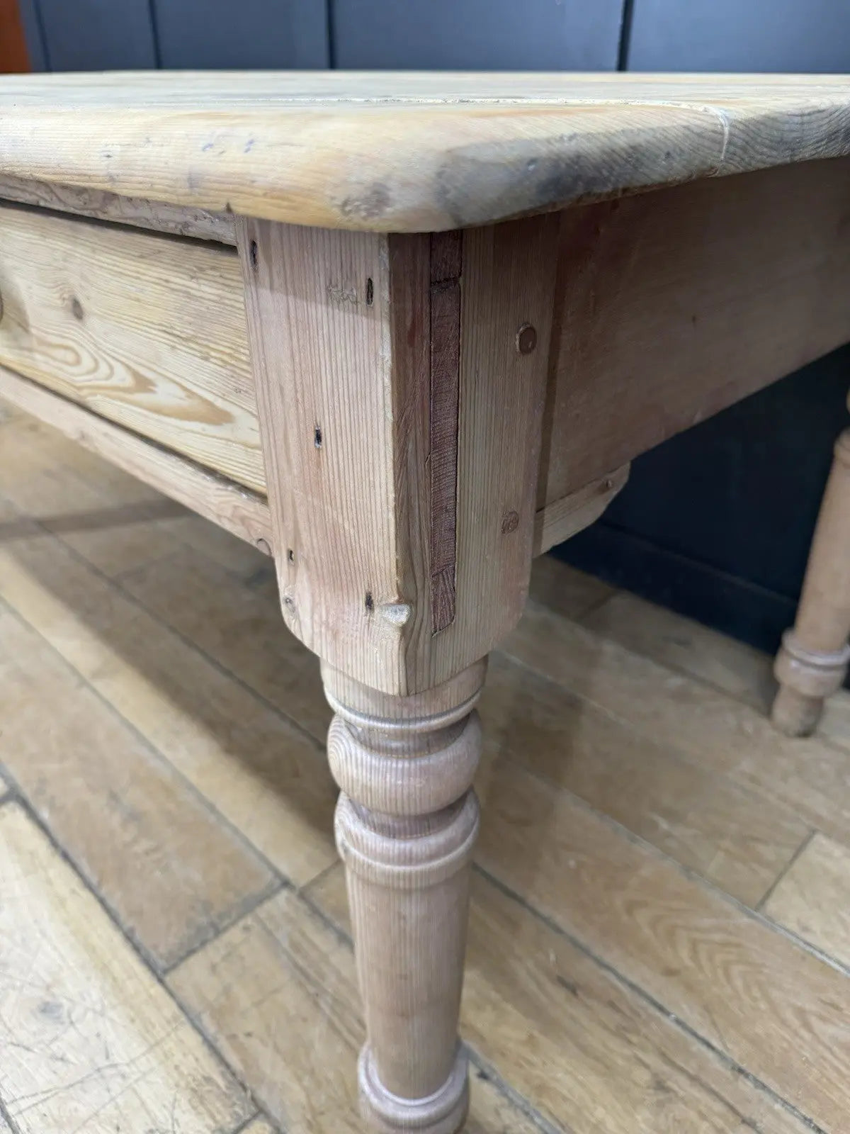 Victorian pine farmhouse dining table brown solid plank top with two drawers and ceramic knobs.
