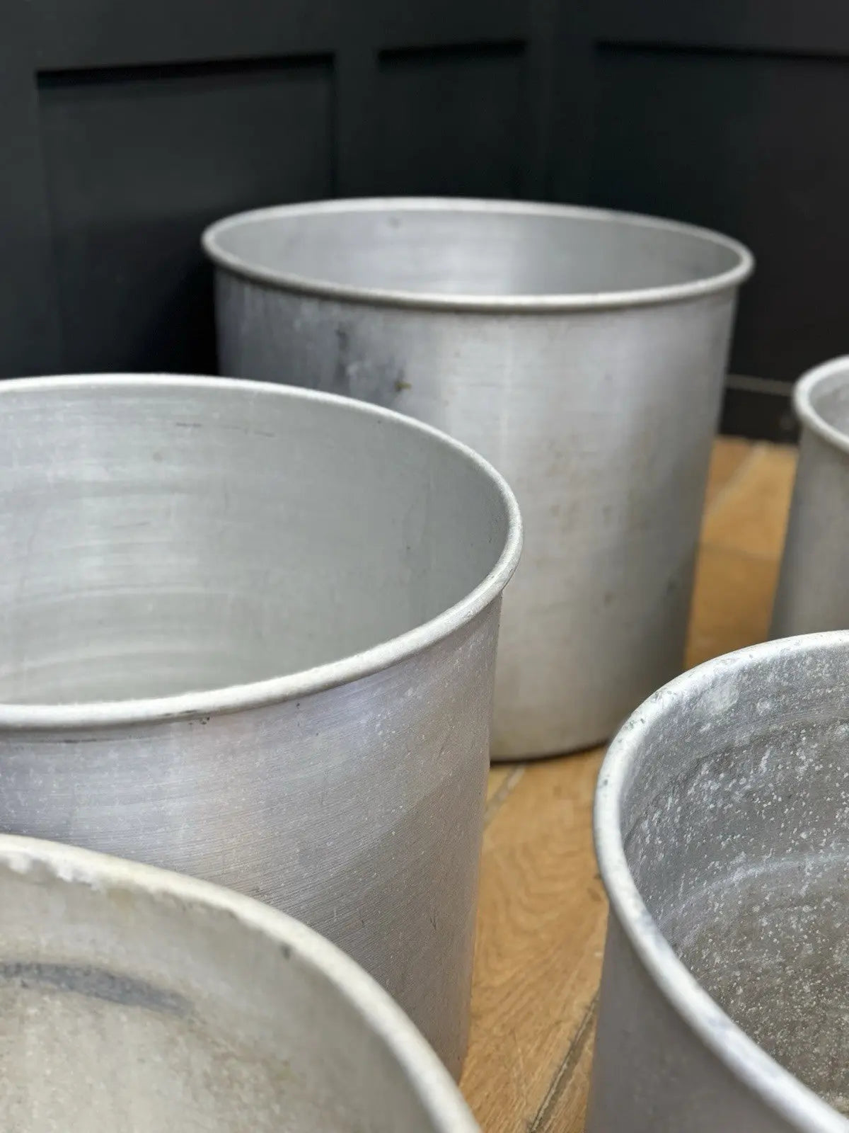Parisotto green aluminium planters set of seven with cylindrical bodies and maker's label.