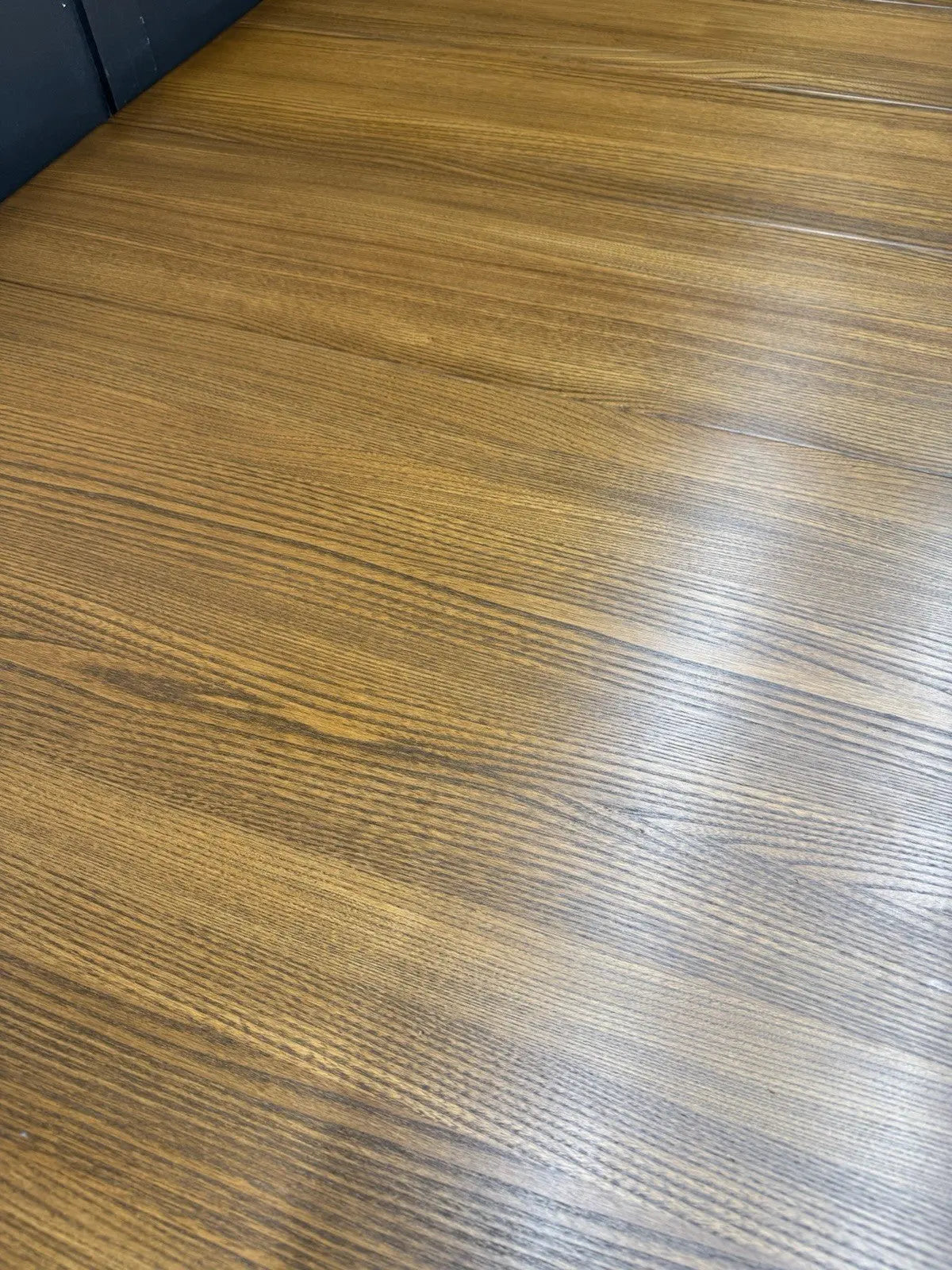 Ercol brown extending dining table with solid elm top and three individual extension leaves.