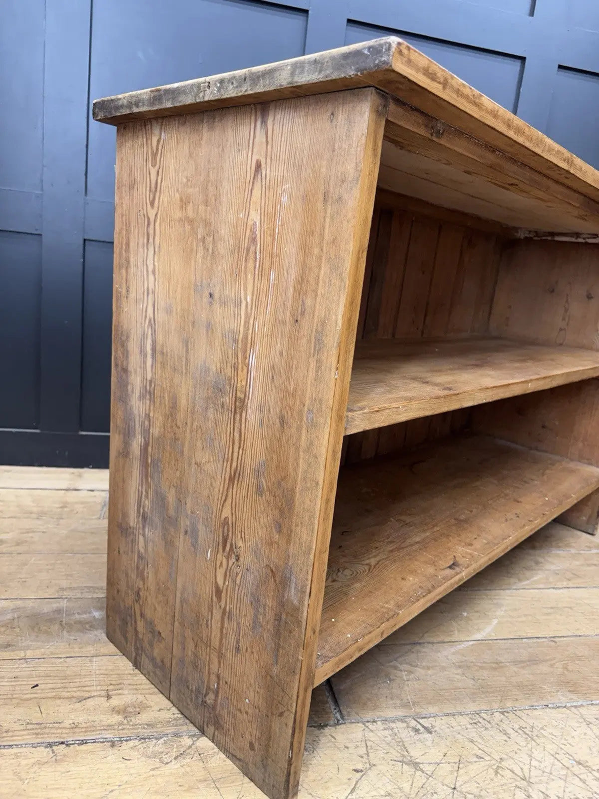 Vintage pine bookcase with warm, aged finish and two open shelves.