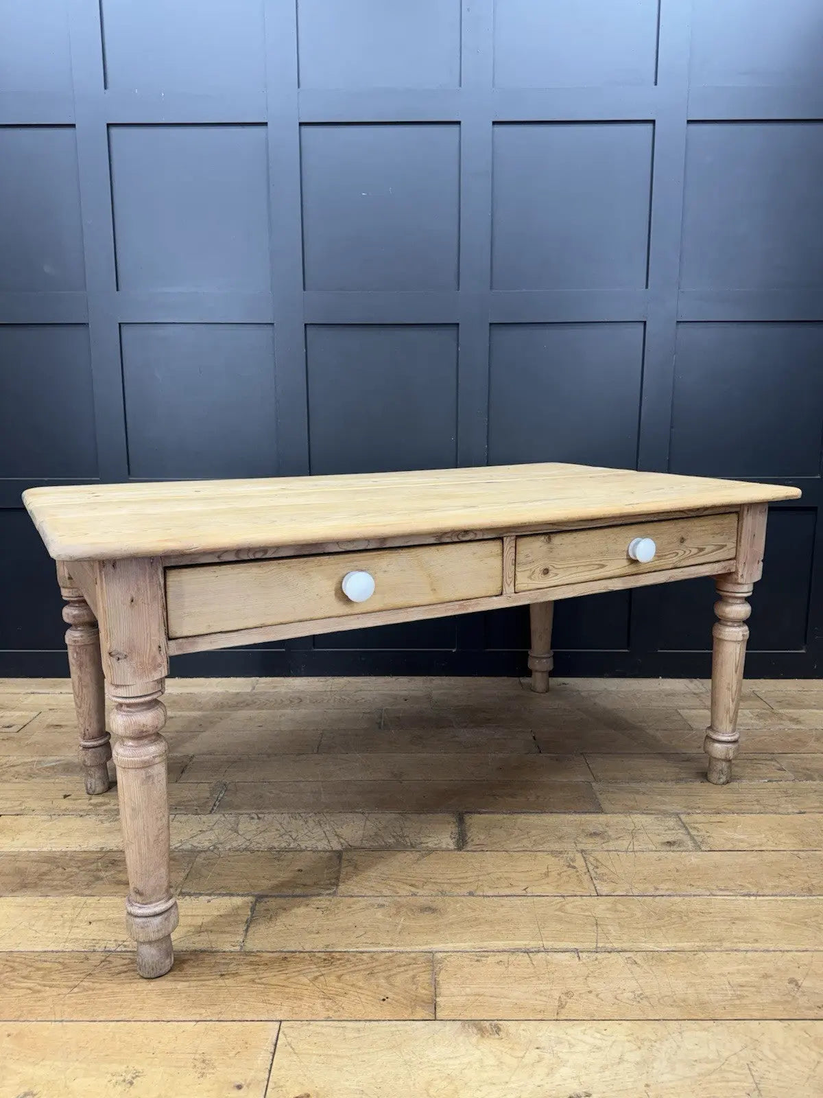 Victorian pine farmhouse dining table brown solid plank top with two drawers and ceramic knobs.