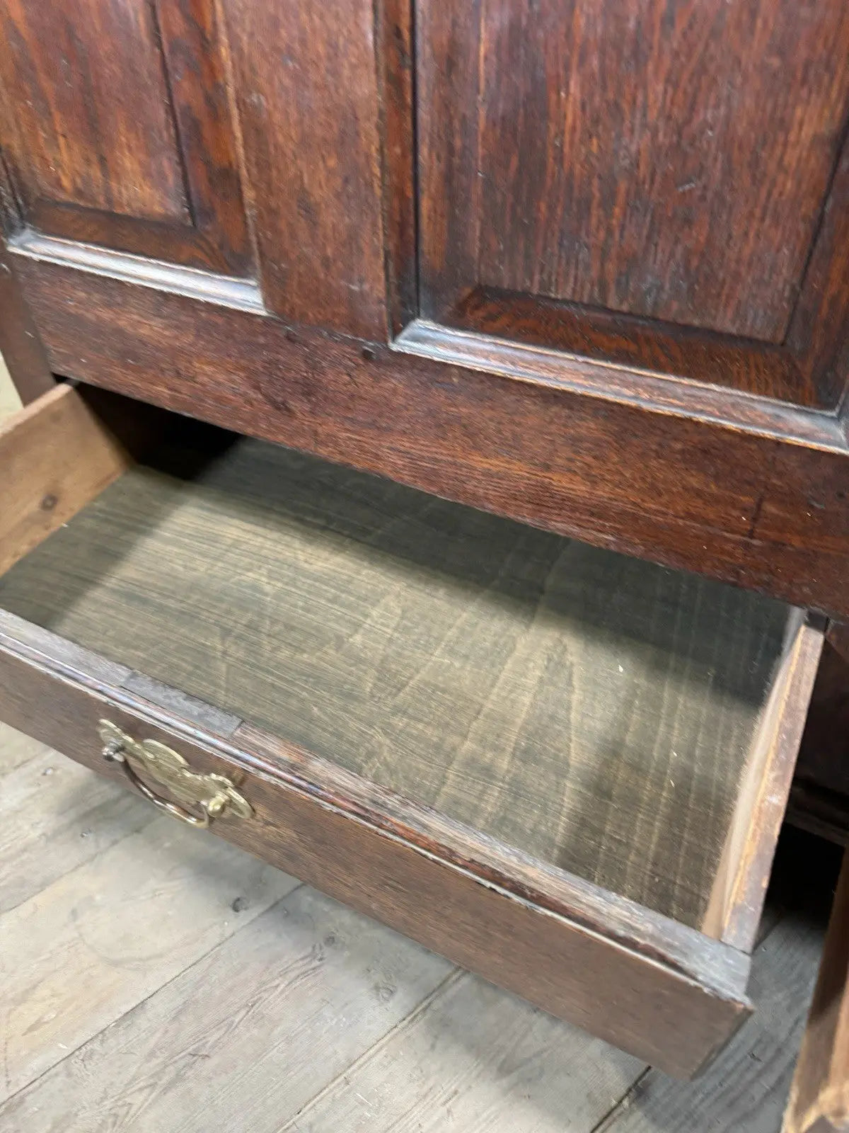 Antique oak mule chest brown four-panelled design with two drawers and rich grain.