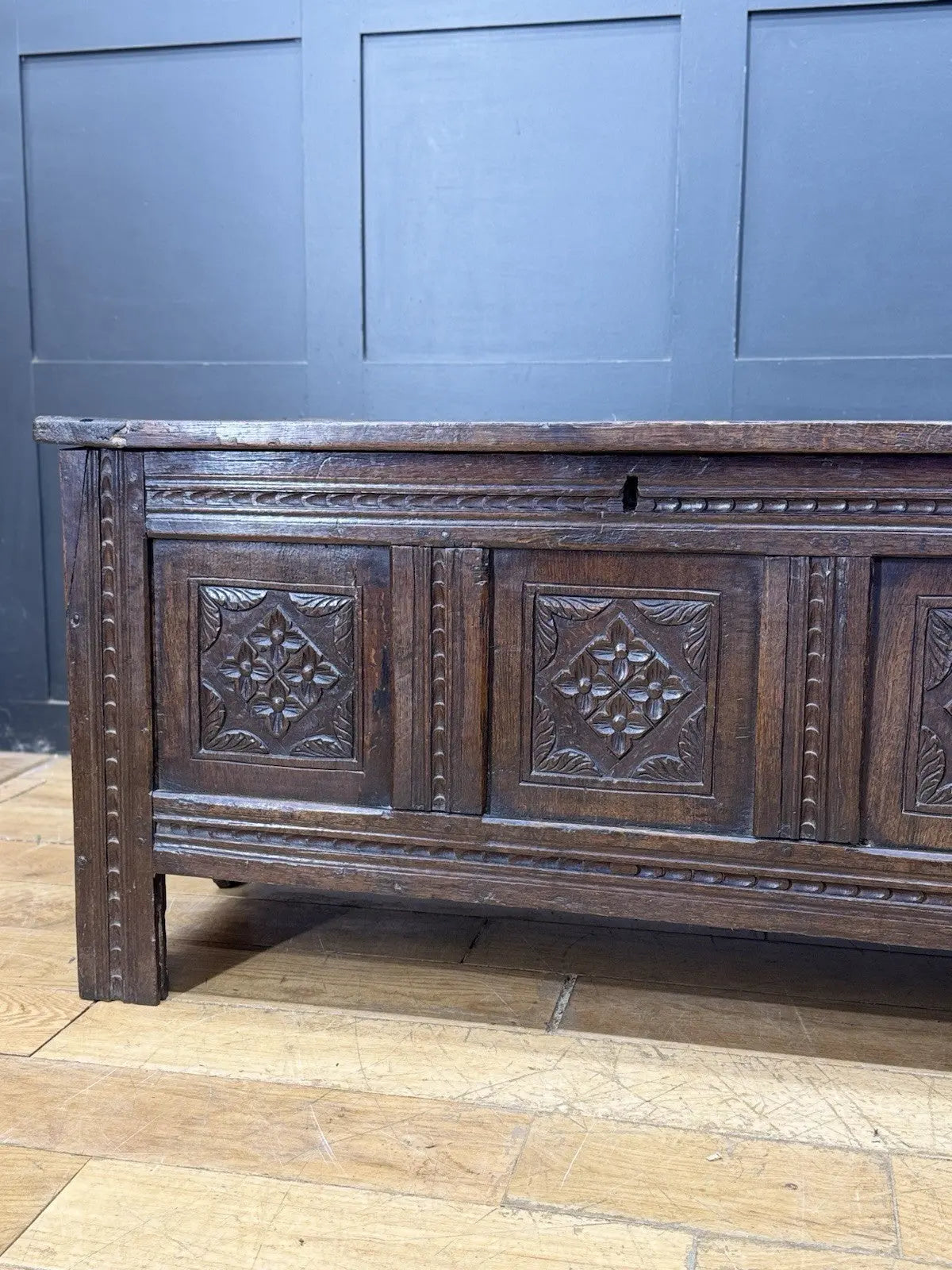 Georgian carved oak hope chest brown with floral motifs and iron hinges.