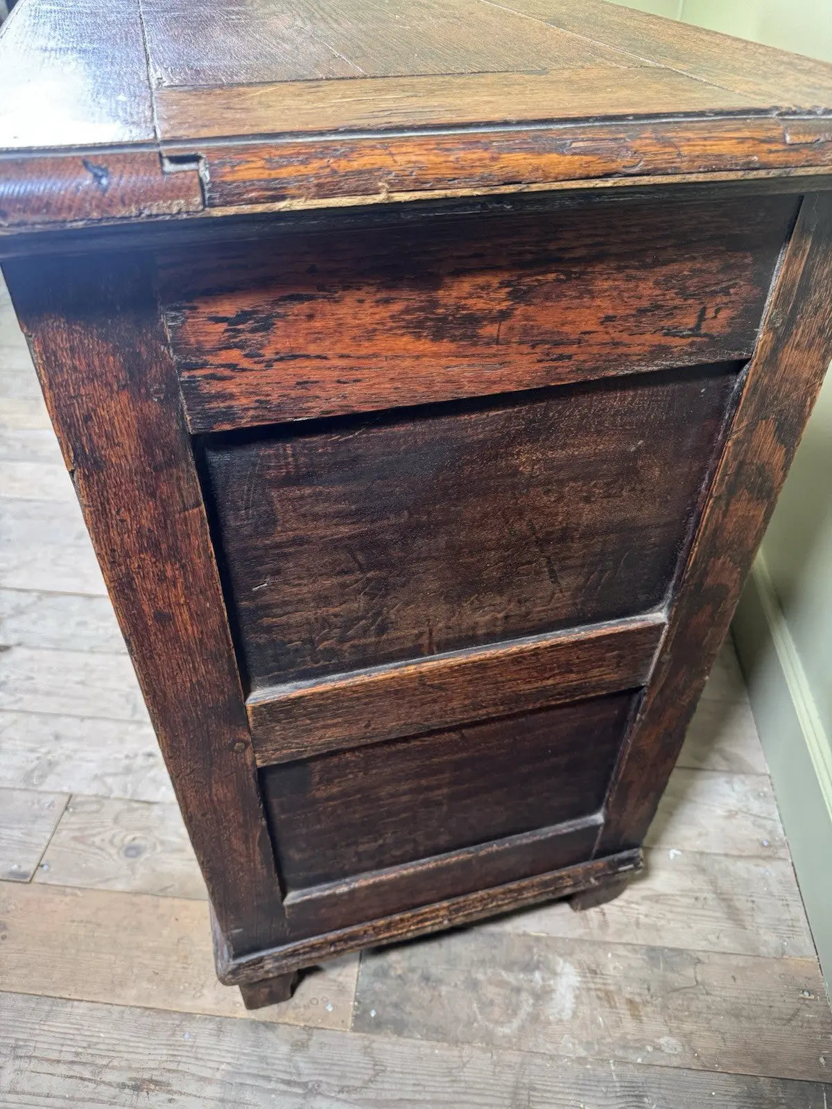 Antique oak mule chest brown four-panelled design with two drawers and rich grain.
