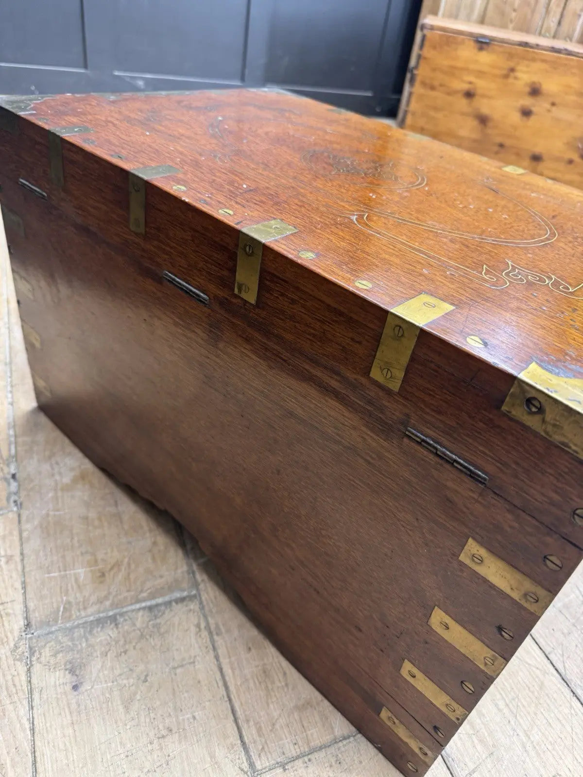 Antique Anglo-Burmese teak campaign chest trunk with brass strapwork and drop-handle.