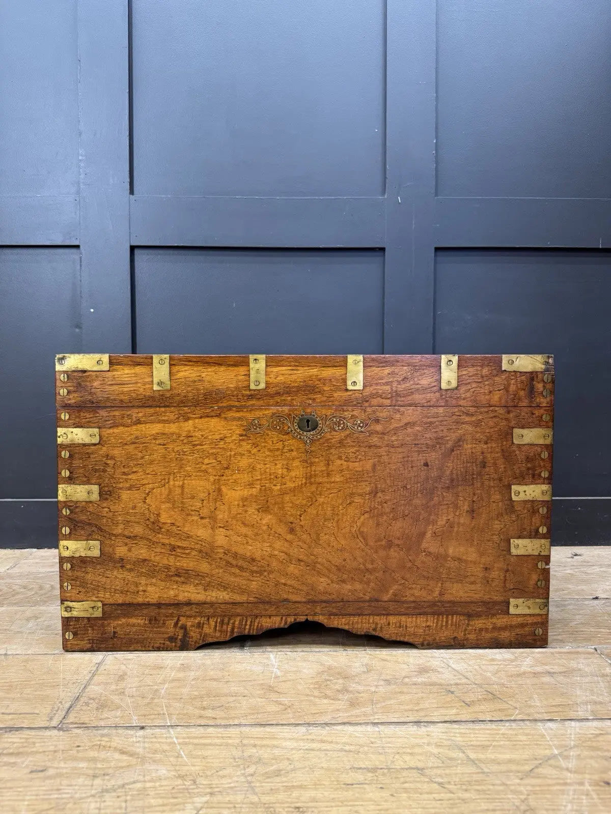 Antique Anglo-Burmese teak campaign chest trunk with brass strapwork and drop-handle.