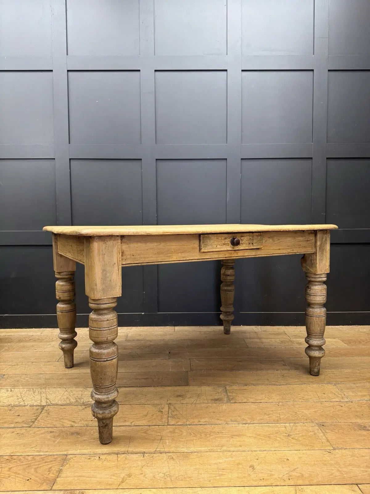 Late Victorian farmhouse kitchen table, scrubbed pine, ring-turned legs, single drawer, timeworn surface.