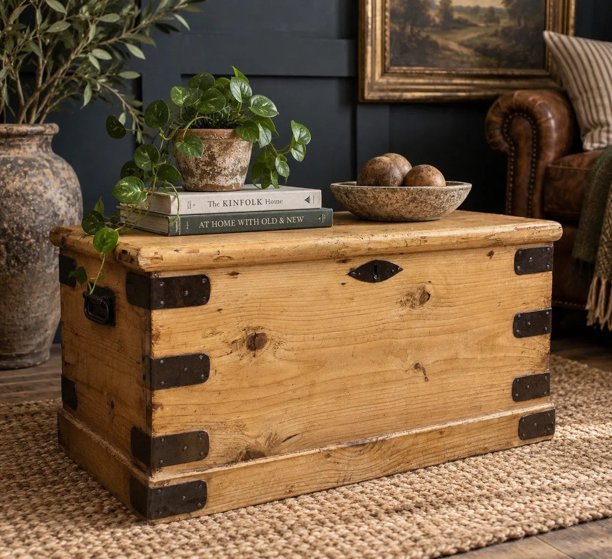 Vintage pine coffee table brown with natural grain and dark metal corner brackets.