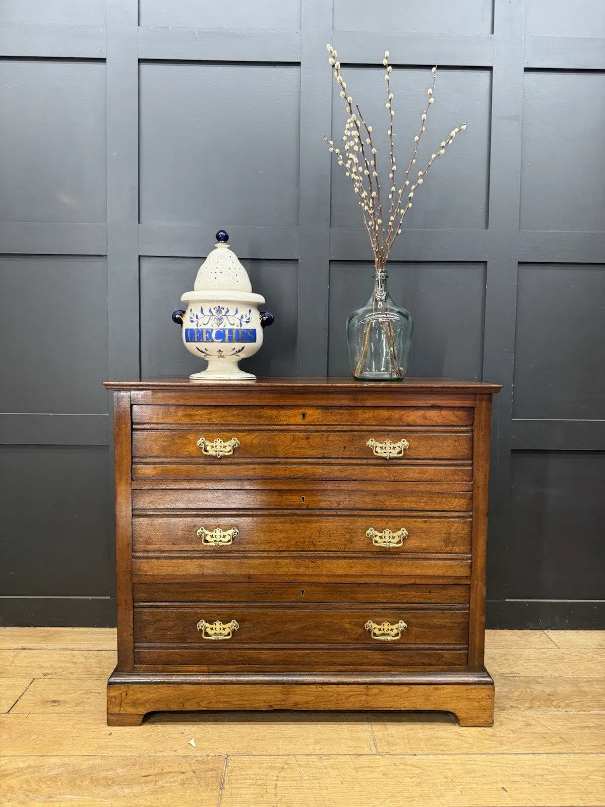 Edwardian brown dresser with three long drawers, decorative brass handles and attractive wood figuring.