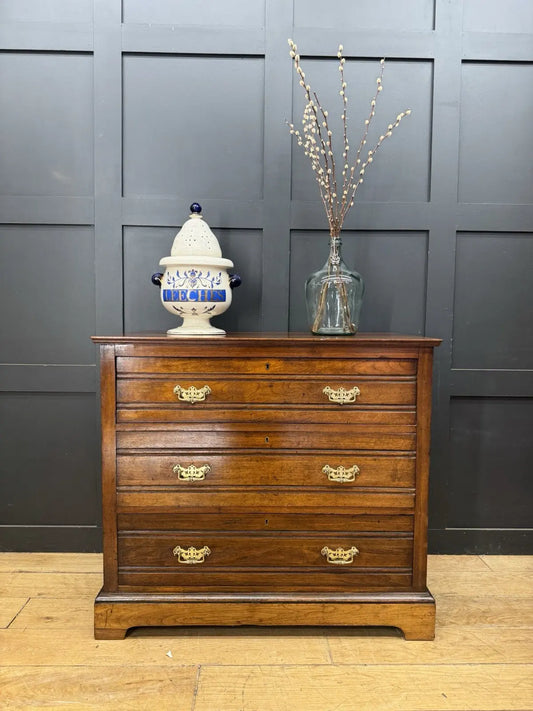 Edwardian brown dresser with three long drawers, decorative brass handles and attractive wood figuring.