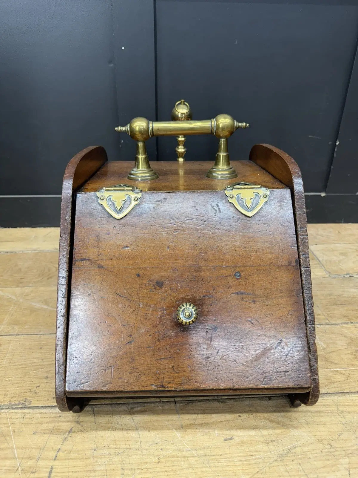 Victorian walnut coal purdonium scuttle box with brass fittings and ornate handle.
