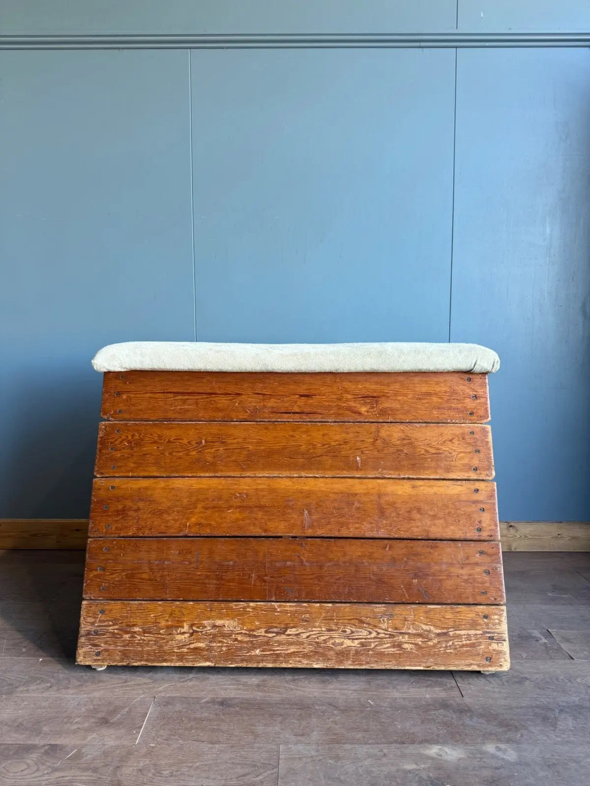 Lodge vintage wooden pommel horse with original maker's label, padded top, and worn patina.