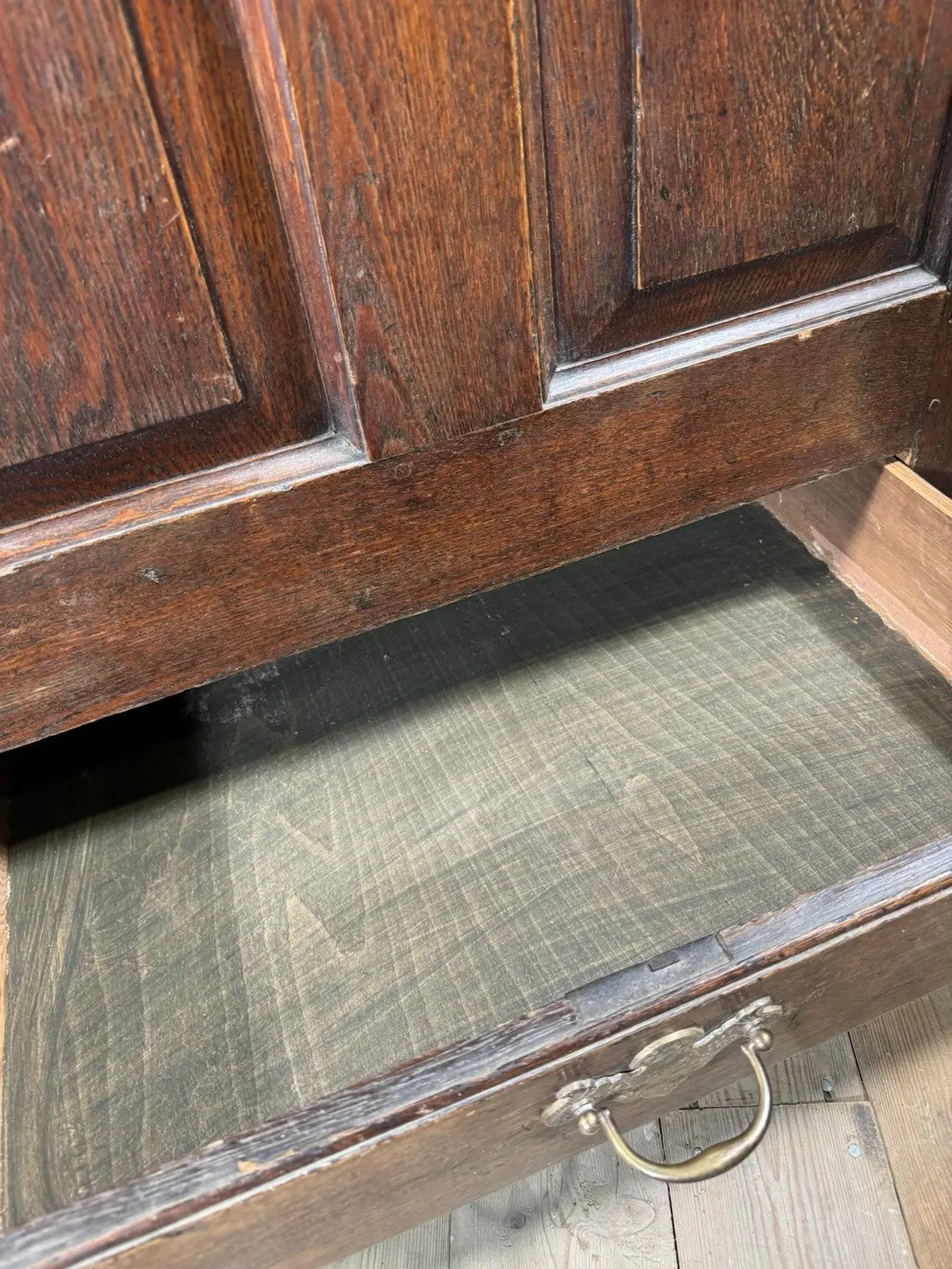 Antique oak mule chest brown four-panelled design with two drawers and rich grain.