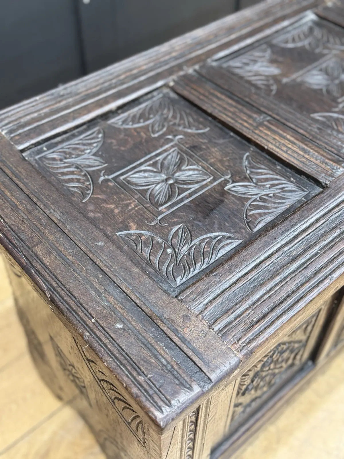 Georgian carved oak hope chest brown with floral motifs and iron hinges.