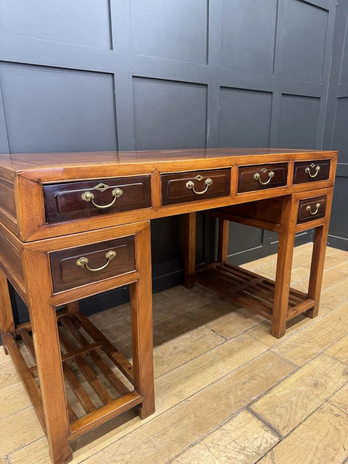 Antique Chinese hardwood writing desk, rich brown finish, elegant traditional pedestal design.