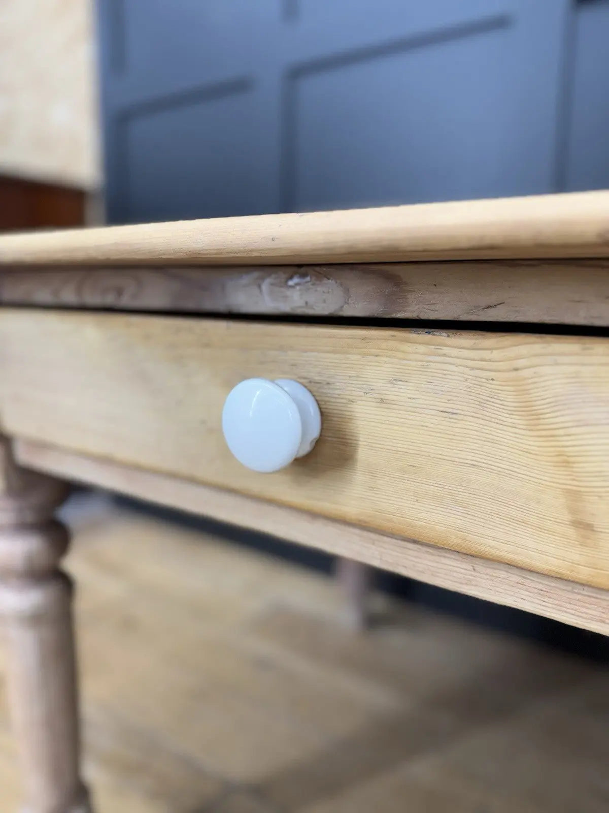 Victorian pine farmhouse dining table brown solid plank top with two drawers and ceramic knobs.