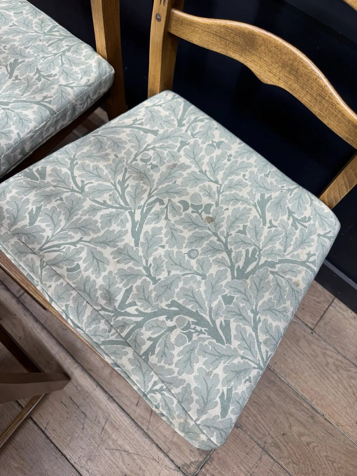 Ercol vintage ladderback dining chairs brown elm beech with green botanical patterned seat pads.