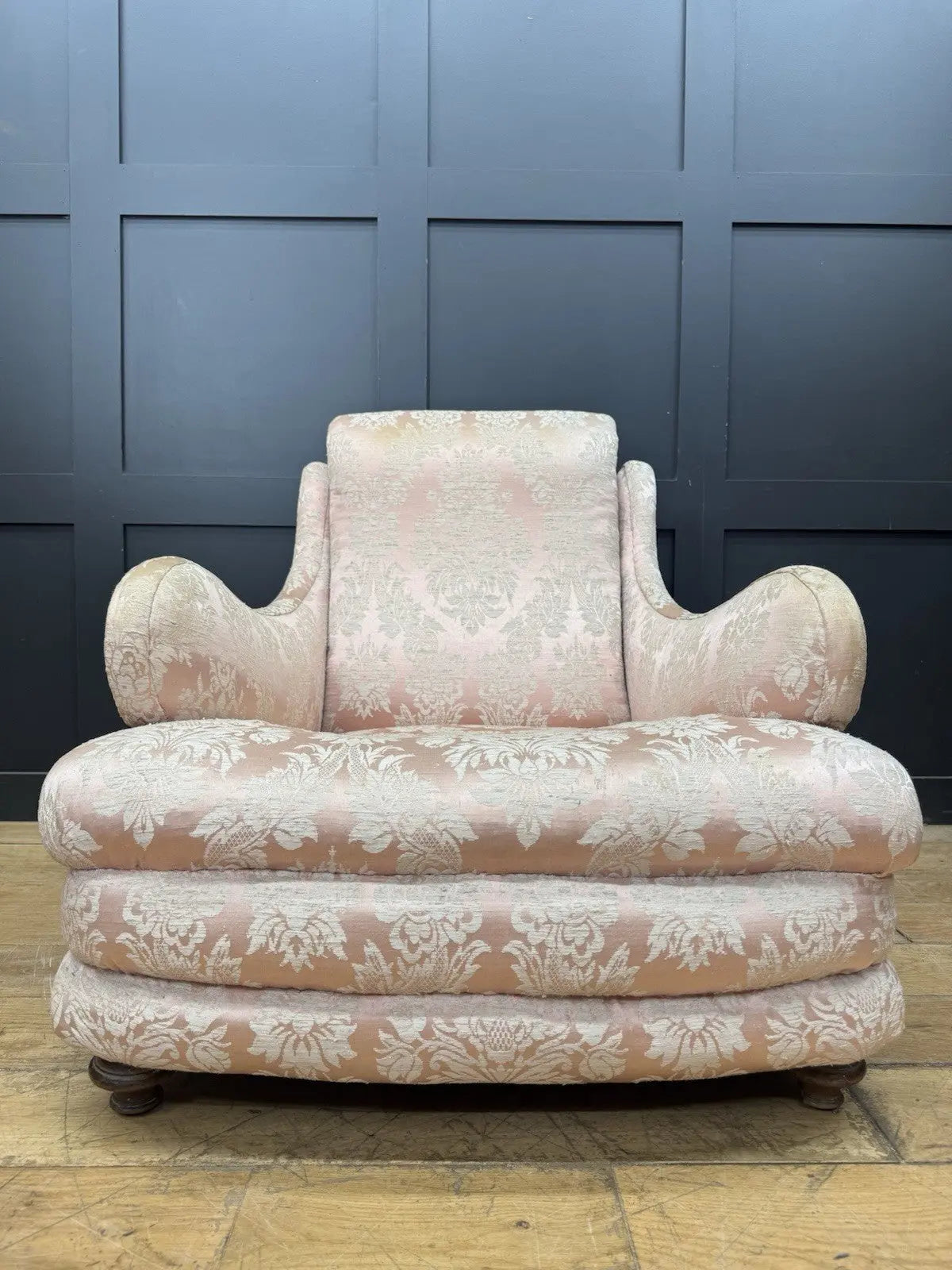 Late Victorian armchair pink silk damask floral pattern with curved rolled arms.