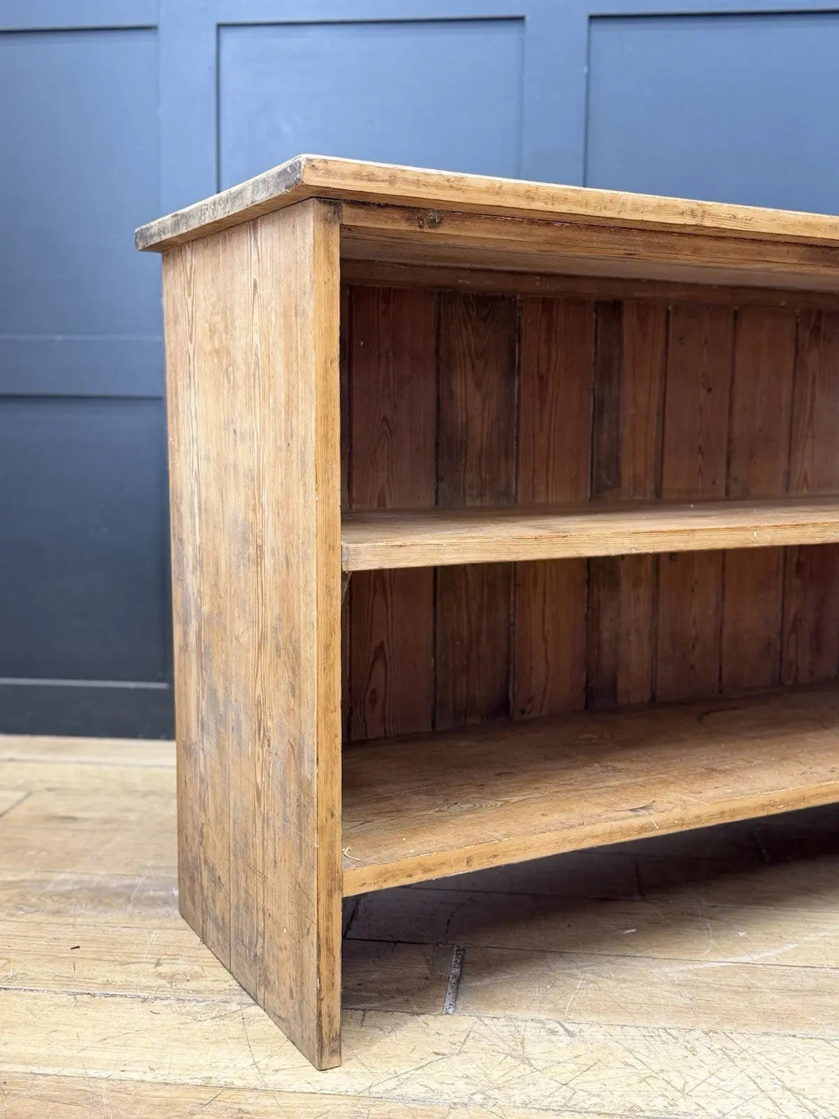 Vintage pine bookcase with warm, aged finish and two open shelves.